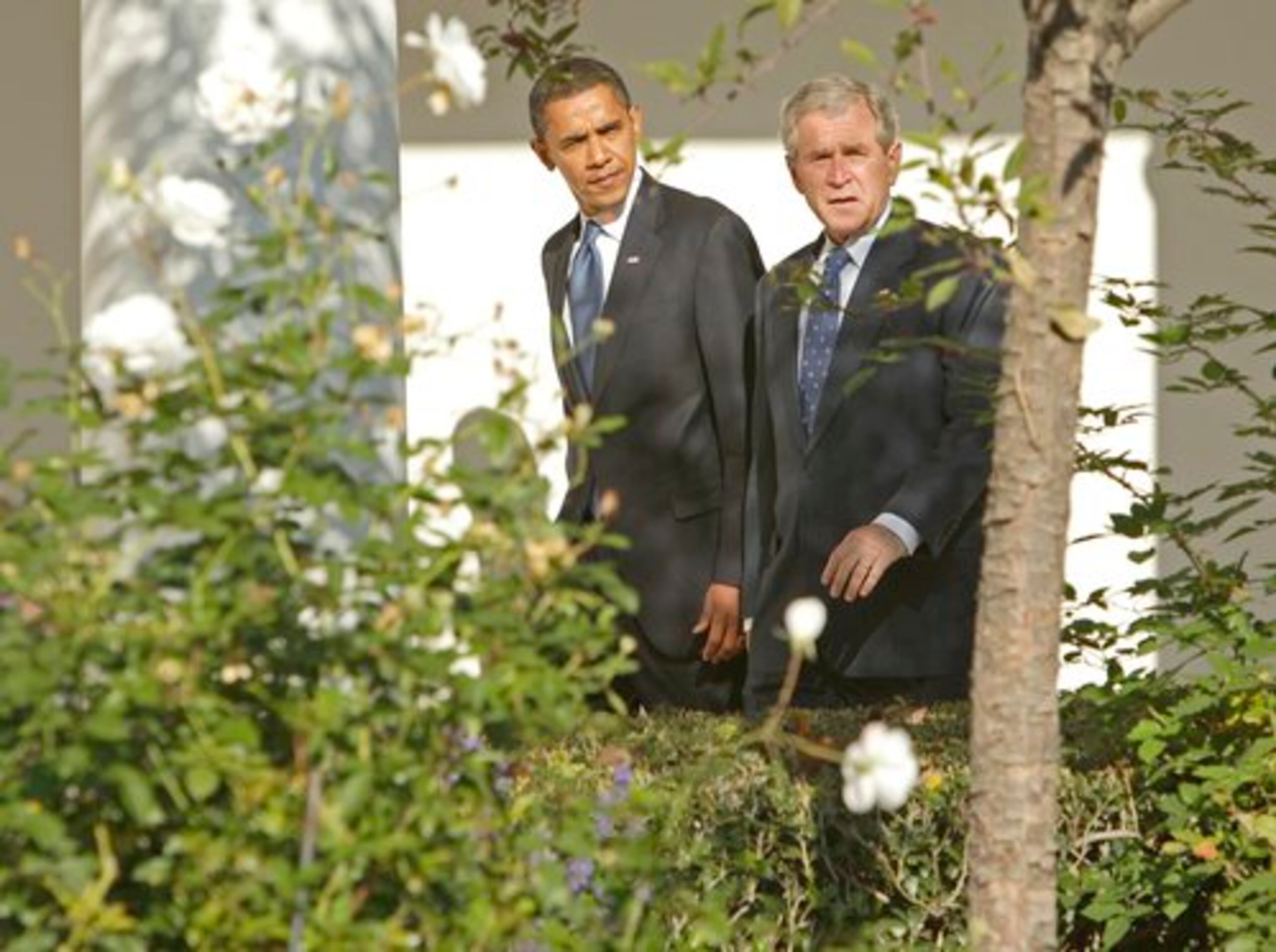 President George W. Bush walks with President-elect Barack Obama along the West Wing Colonnade at the White House in Washington on Monday to the Oval Office for a private meeting.