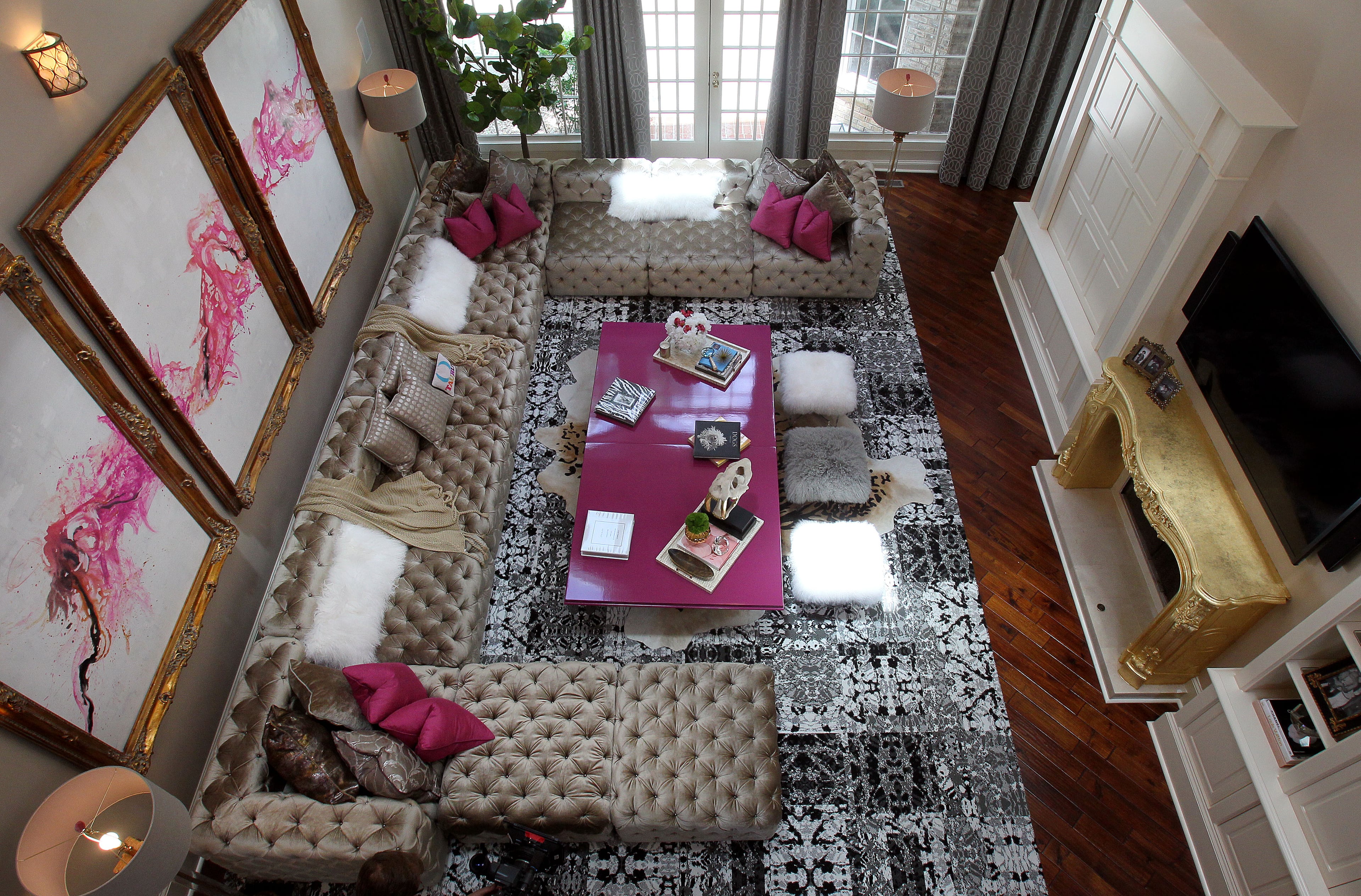 "Real Housewives of Atlanta" cast member Kandi Burruss has settled into her new home in southwest Atlanta. The 7-bedroom, 9.5-bathroom home features a number of exclusive amenities, like an indoor pool, elevator and a super-private spa room tucked behind the family room. Burruss' family room, shown here, is decorated with pops of fuchsia and gold.