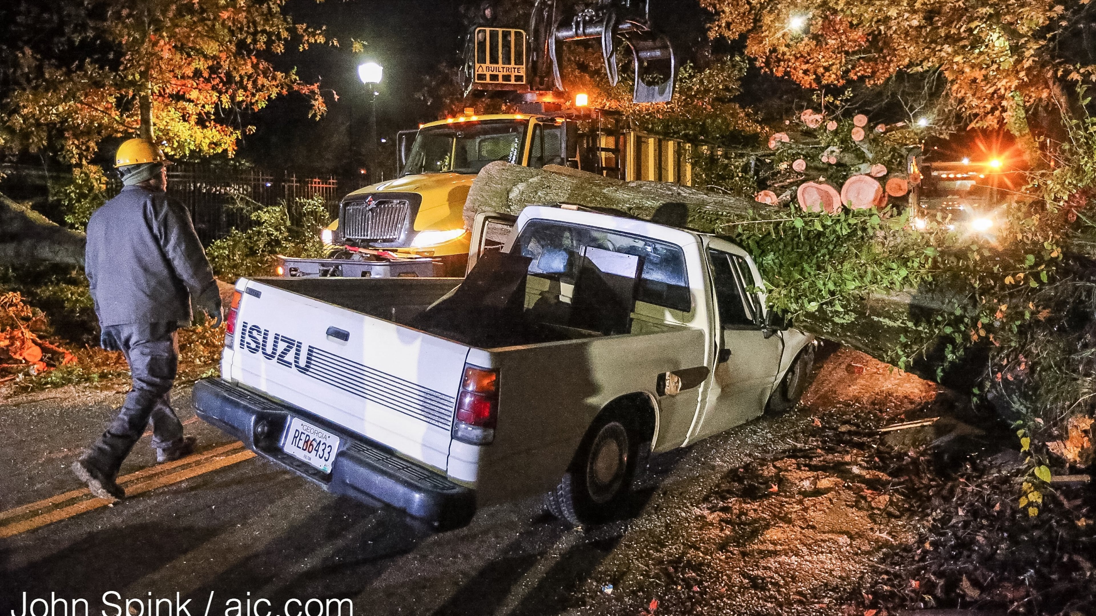 A truck driver was slightly injured when a tree fell on his truck Thursday on Sells Avenue and Lawton Street in Atlanta. JOHN SPINK / JSPINK@AJC.COM