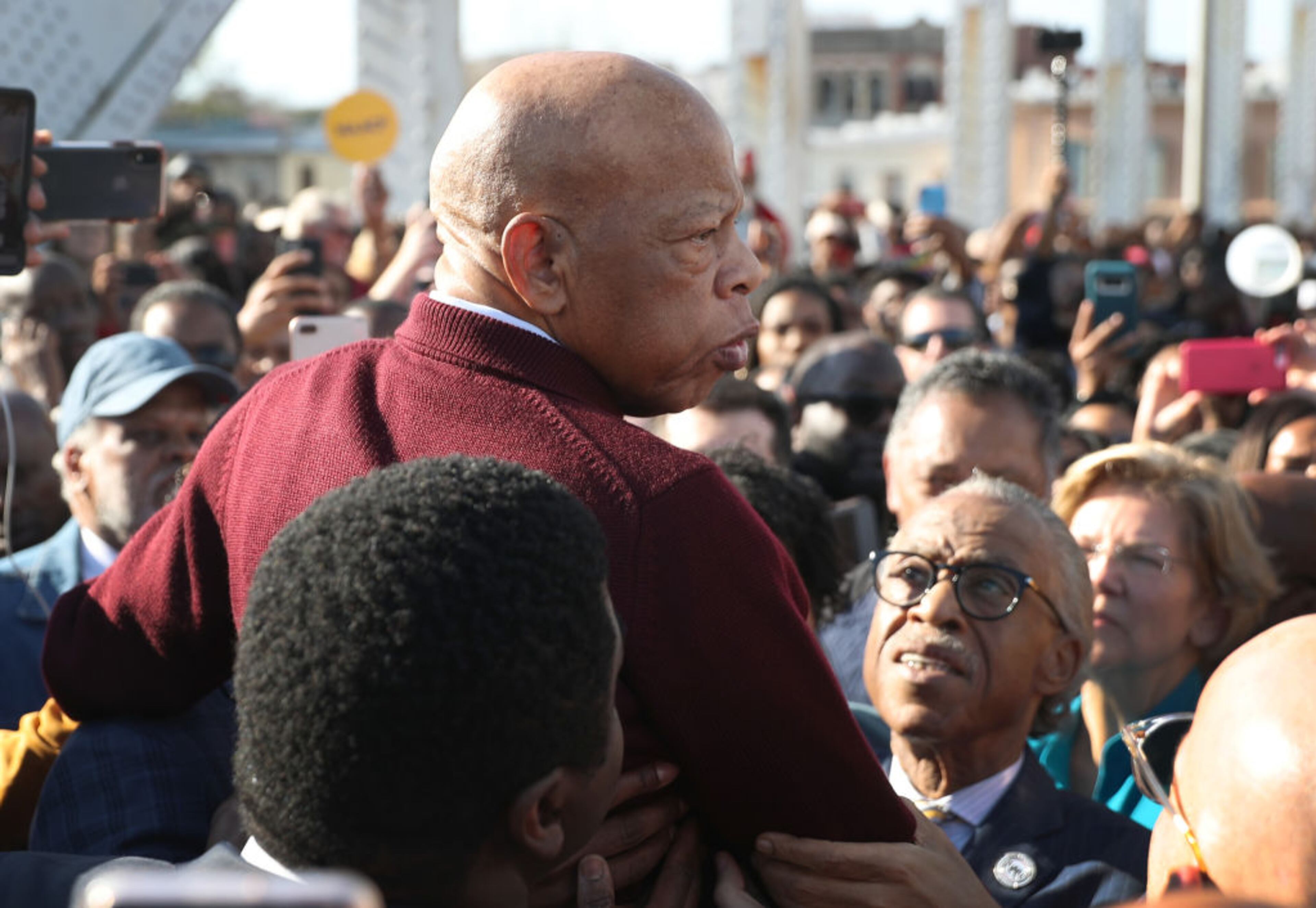 SELMA, ALABAMA - MARCH 01: Rep. John Lewis (D-GA) is held aloft by Rev. Al Sharpton and others as he speaks to the crowd at the Edmund Pettus Bridge crossing reenactment marking the 55th anniversary of Selma's Bloody Sunday on March 1, 2020 in Selma, Alabama. Mr. Lewis marched for civil rights across the bridge 55 years ago. Some of the 2020 Democratic presidential candidates attended the Selma bridge crossing jubilee ahead of Super Tuesday. (Photo by Joe Raedle/Getty Images)