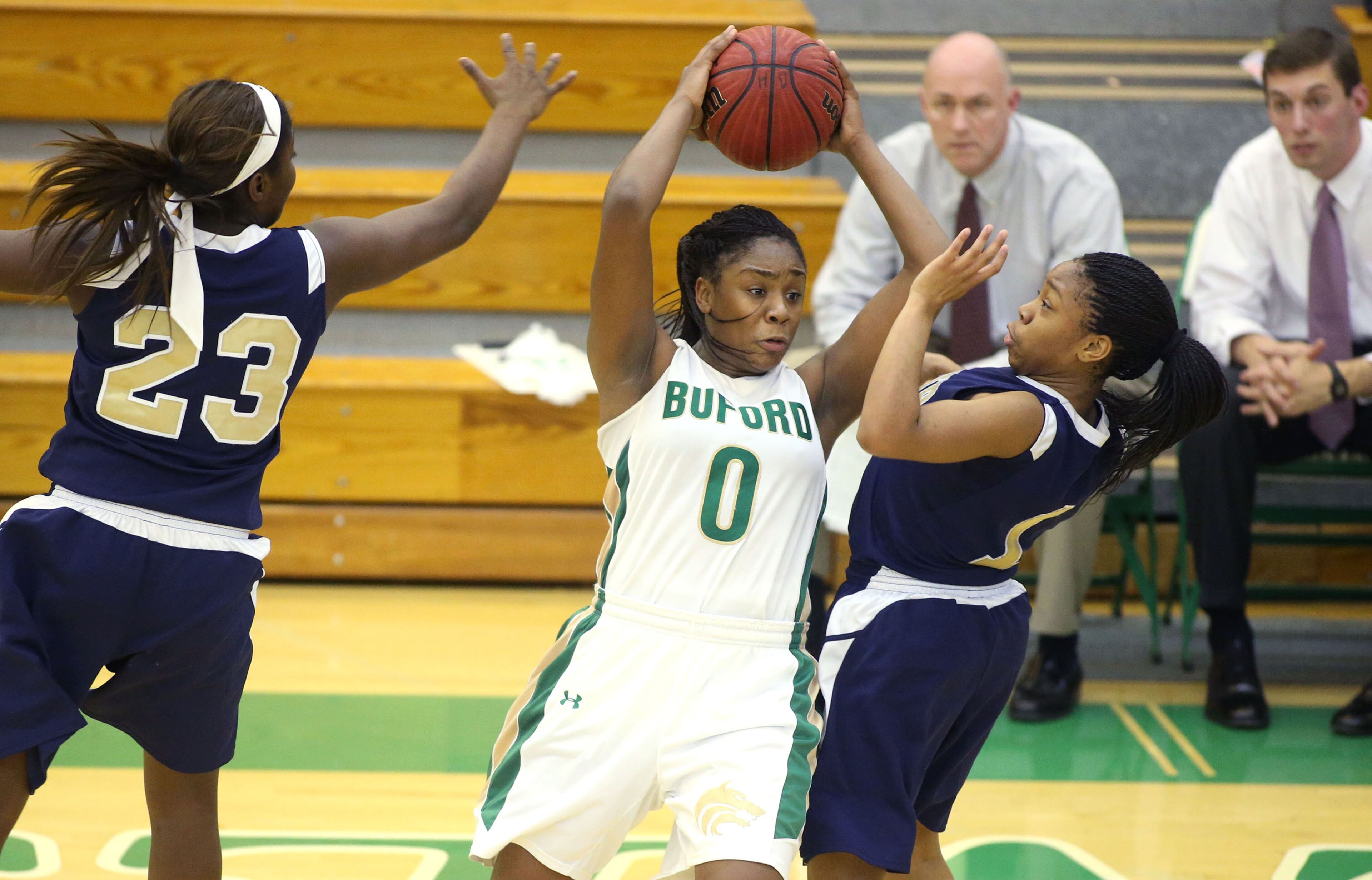 Buford's Camille Anderson (0) looks to pass under pressure from Decatur's Kayla Thomas, left, and Jayla Morrow, right, in their game Monday night in Buford.. Buford defeated Decatur 41-28 in the second round of the Class AAA state basketball tournament. JASON GETZ / SPECIAL
