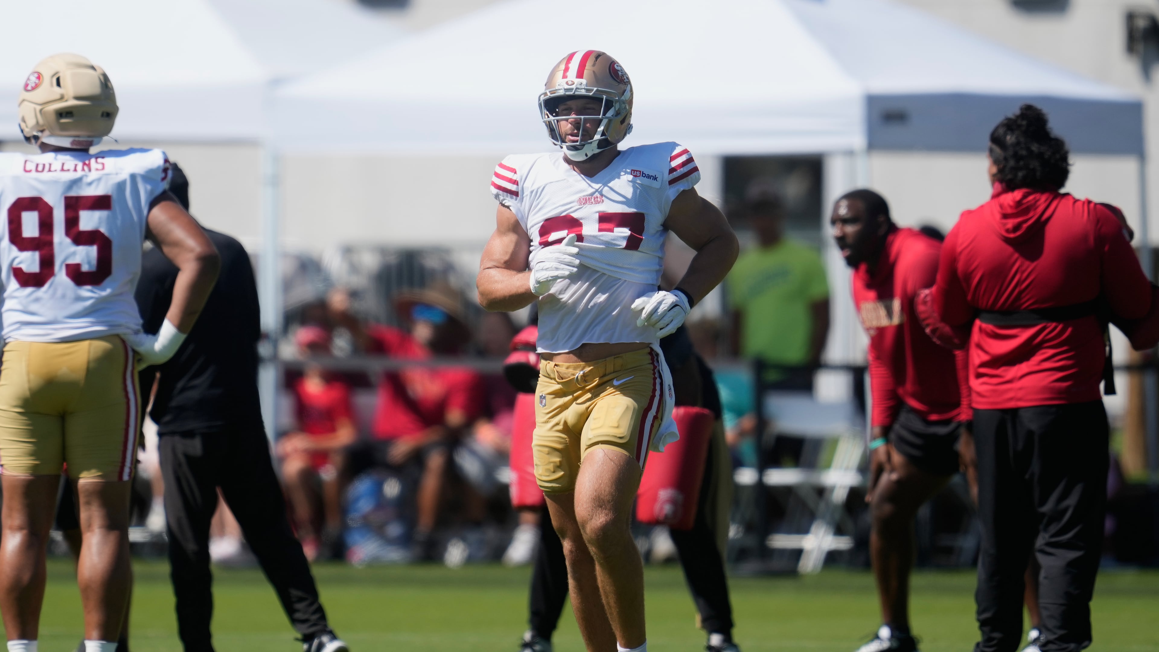 San Francisco 49ers defensive end Nick Bosa jogs on the field during the NFL football team's training camp, Monday, Aug. 3, 2026, in Santa Clara, Calif. (AP Photo/Jeff Chiu)