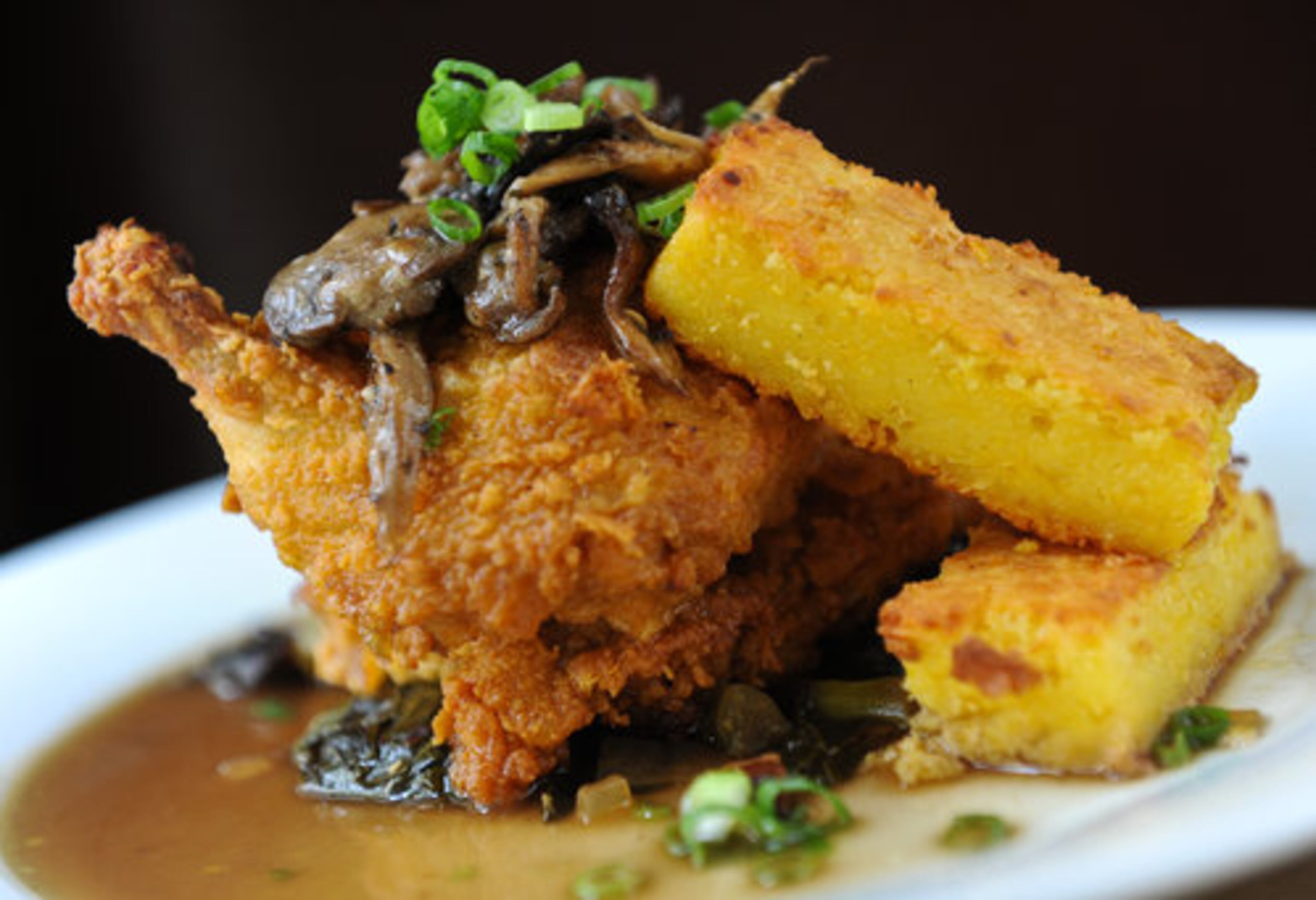 Iron skillet-fried half chicken with bacon braised collard greens and sweet corn pudding in mushroom-herb broth from Wisteria in Atlanta. Jenny Turknett says, "Wisteria has blossomed into a treasured component of our culinary landscape." Three stars.