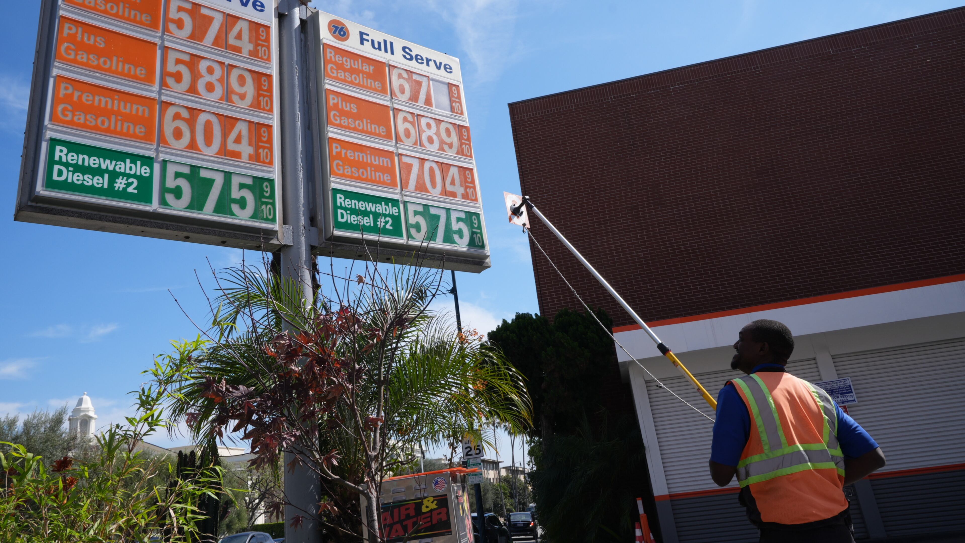 Gas prices are manually increased in Beverly Hills, Calif., Tuesday, March 3, 2026. (AP Photo/Damian Dovarganes)