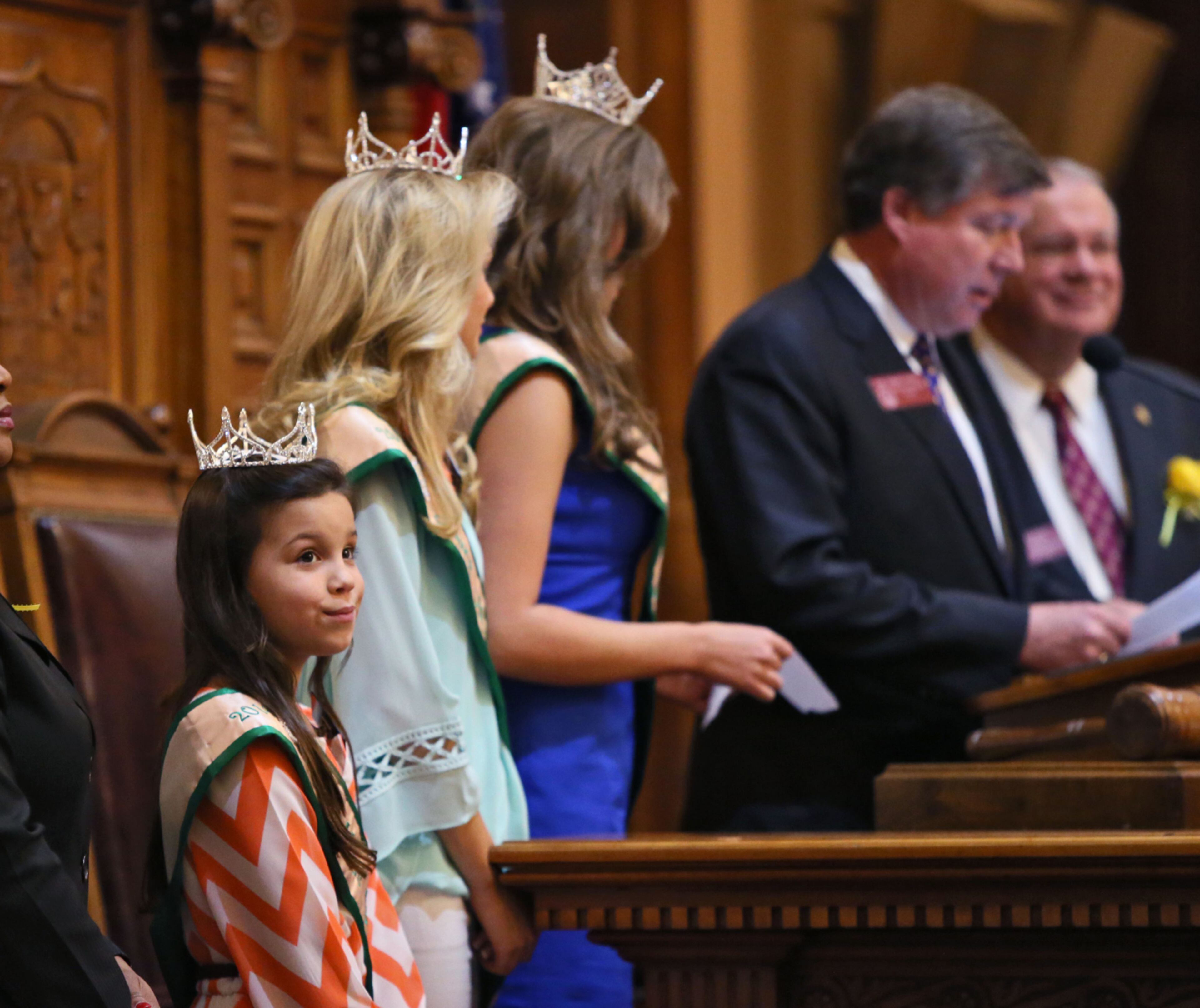 QUEENS DAY--March 3, 2015 - Atlanta - Tiny Miss Georgia Peach, Olivia Rozell, of Bonaire, looks out at the house as the Georgia Peach Queens are recognized during today's session. The House passed a plethora of bills today, including HB 71, which requires greater transparency from the Pardon and Paroles Board, and HB 190, which requires popular ride-sharing services like Uber and Lyft to have insurance for their drivers. The House will also passed HB 315, changing the name of the Technical College System of Georgia to the Georgia Career College System. BOB ANDRES / BANDRES@AJC.COM