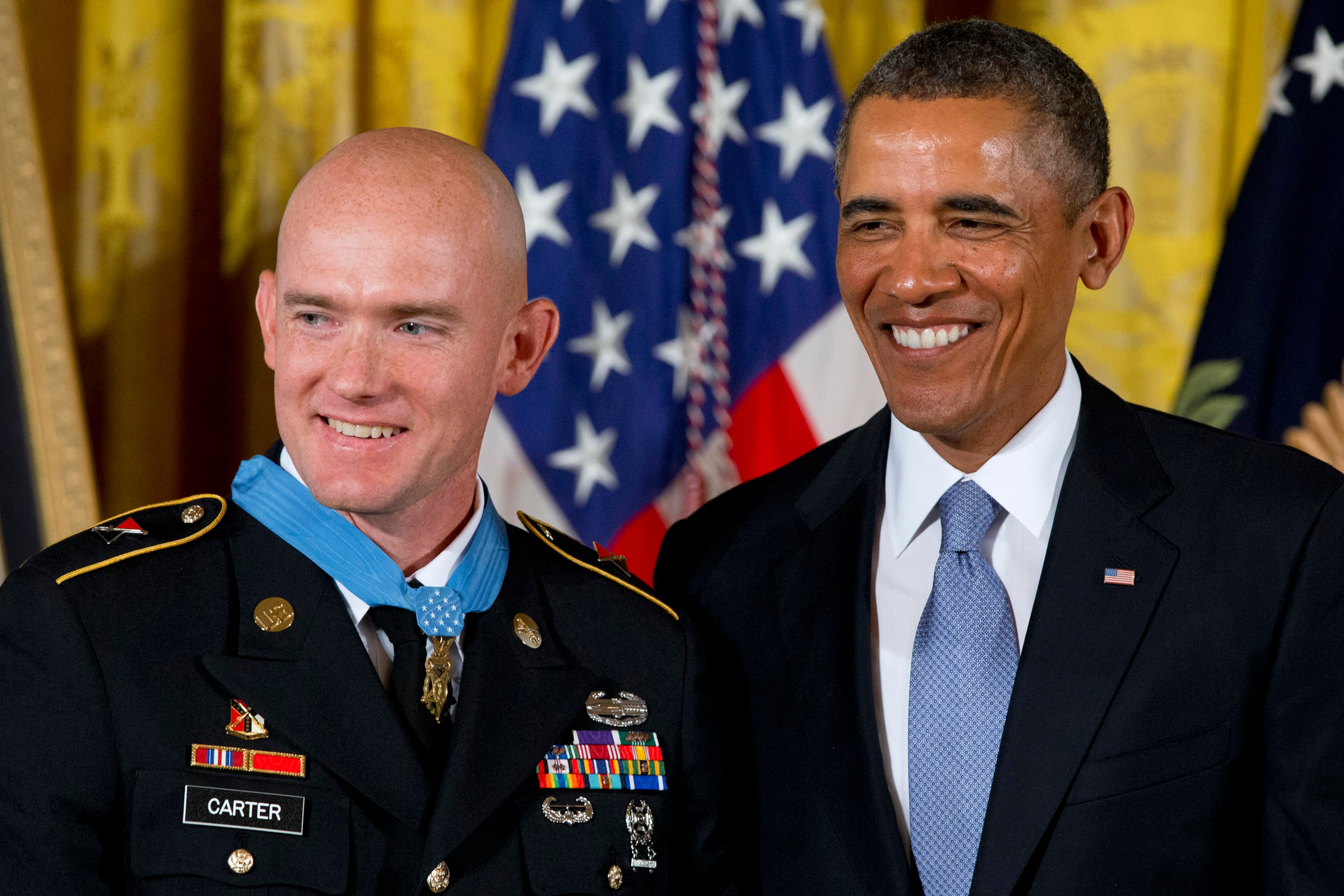 President Barack Obama stands with US Army Staff Sgt. Ty M. Carter after awarding him the Medal of Honor for conspicuous gallantry, Monday, Aug. 26, 2013, during a ceremony in the East Room of the White House in Washington. Carter received the medal for his courageous actions while serving as a cavalry scout with Bravo Troop, 3rd Squadron, 61st Cavalry Regiment, 4th Brigade Combat Team, 4th Infantry Division, during combat operations in Kamdesh District, Nuristan Province, Afghanistan on Oct. 3, 2009. Carter is the fifth living recipient to be awarded the Medal of Honor for actions in Iraq or Afghanistan. (AP Photo/Jacquelyn Martin)