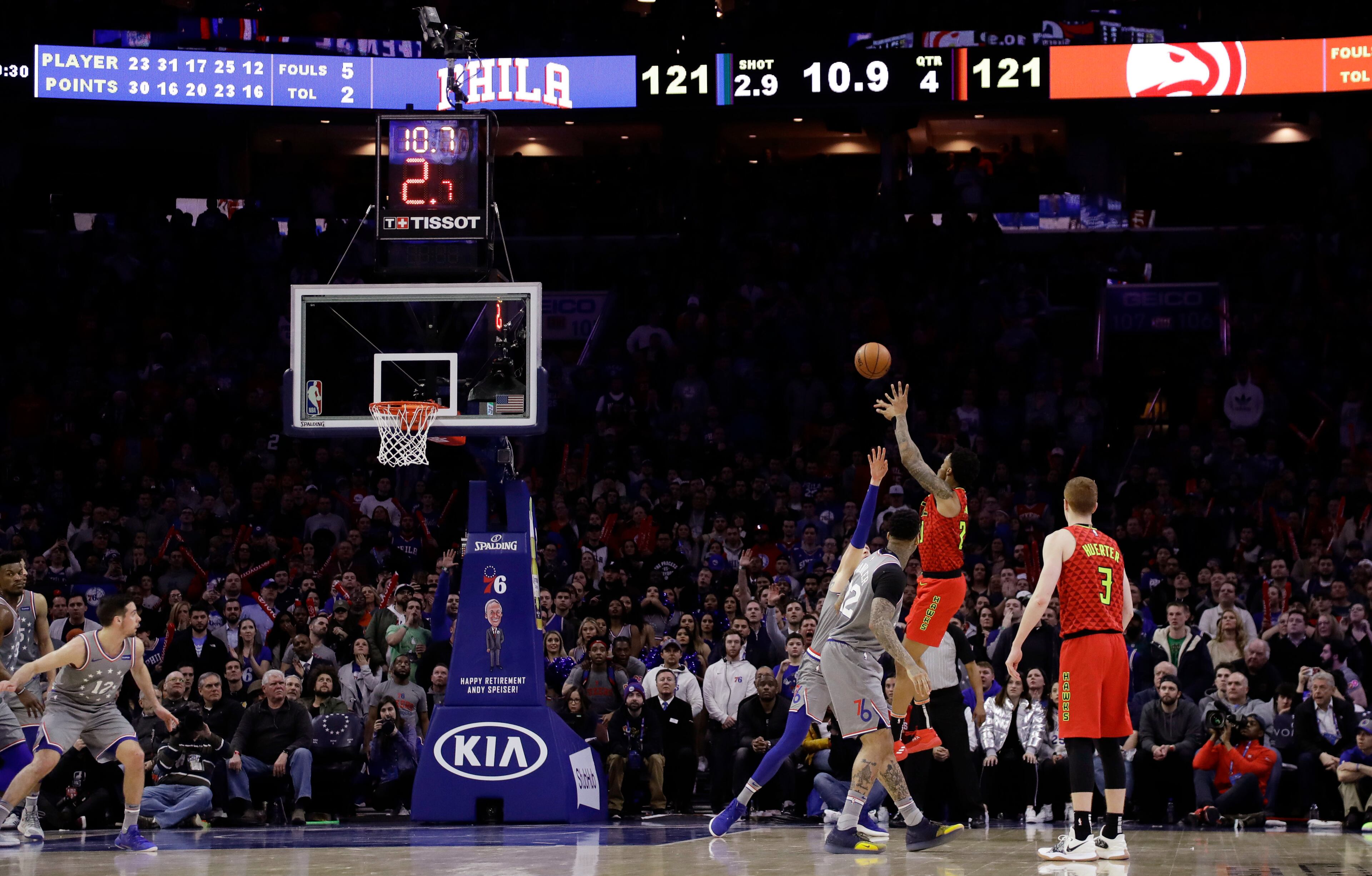 Atlanta Hawks' John Collins, second from right, shoots the go-ahead basket during the final minute of the team's NBA basketball game against the Philadelphia 76ers, Friday, Jan. 11, 2019, in Philadelphia. Atlanta won 123-121. (AP Photo/Matt Slocum)