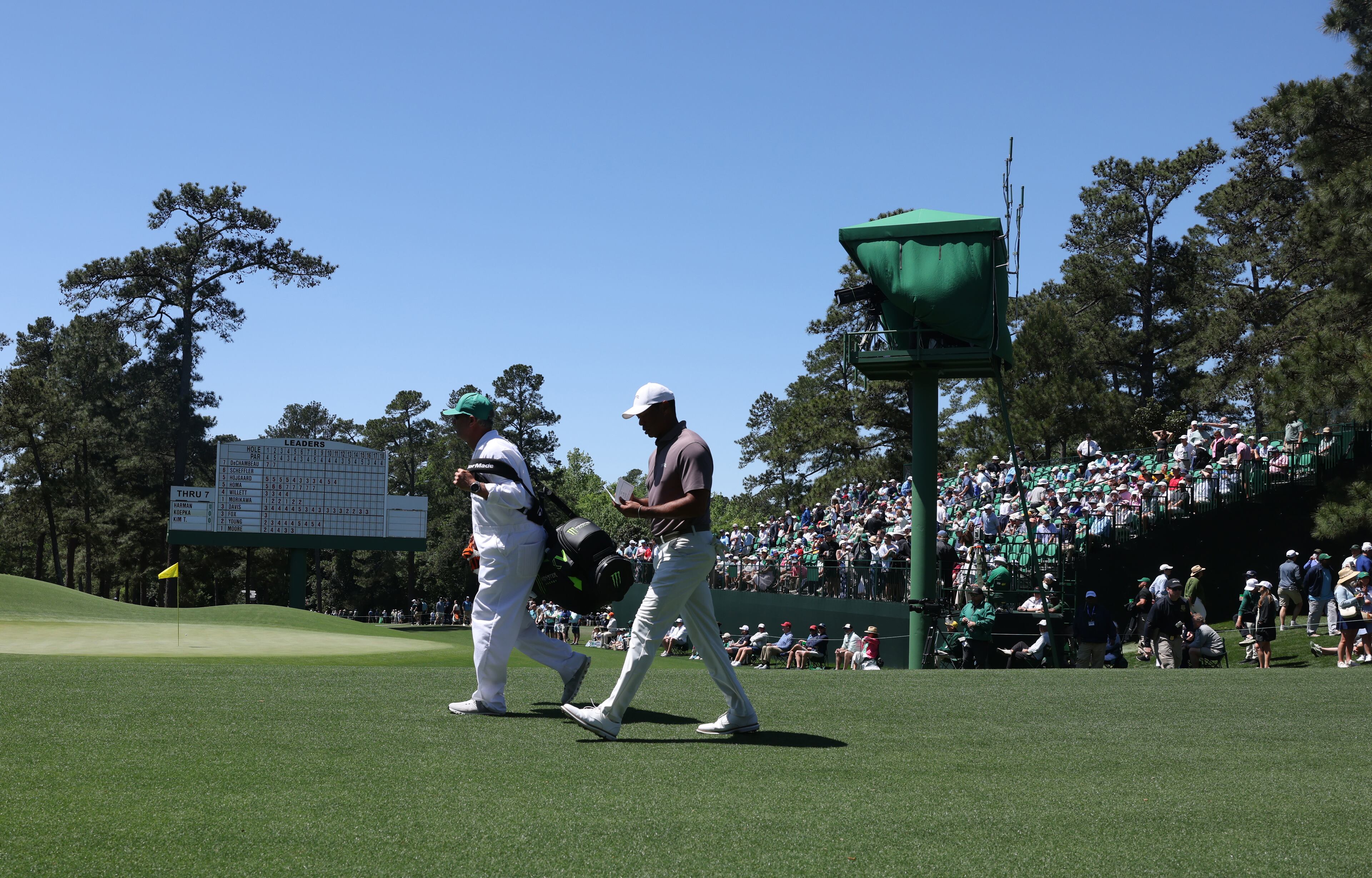 Tiger Woods and caddie Lance Bennett walk down 9th fairway during second round of the 2024 Masters Tournament at Augusta National Golf Club, Friday, April 12, 2024, in Augusta, Ga. Jason Getz / Jason.Getz@ajc.com)