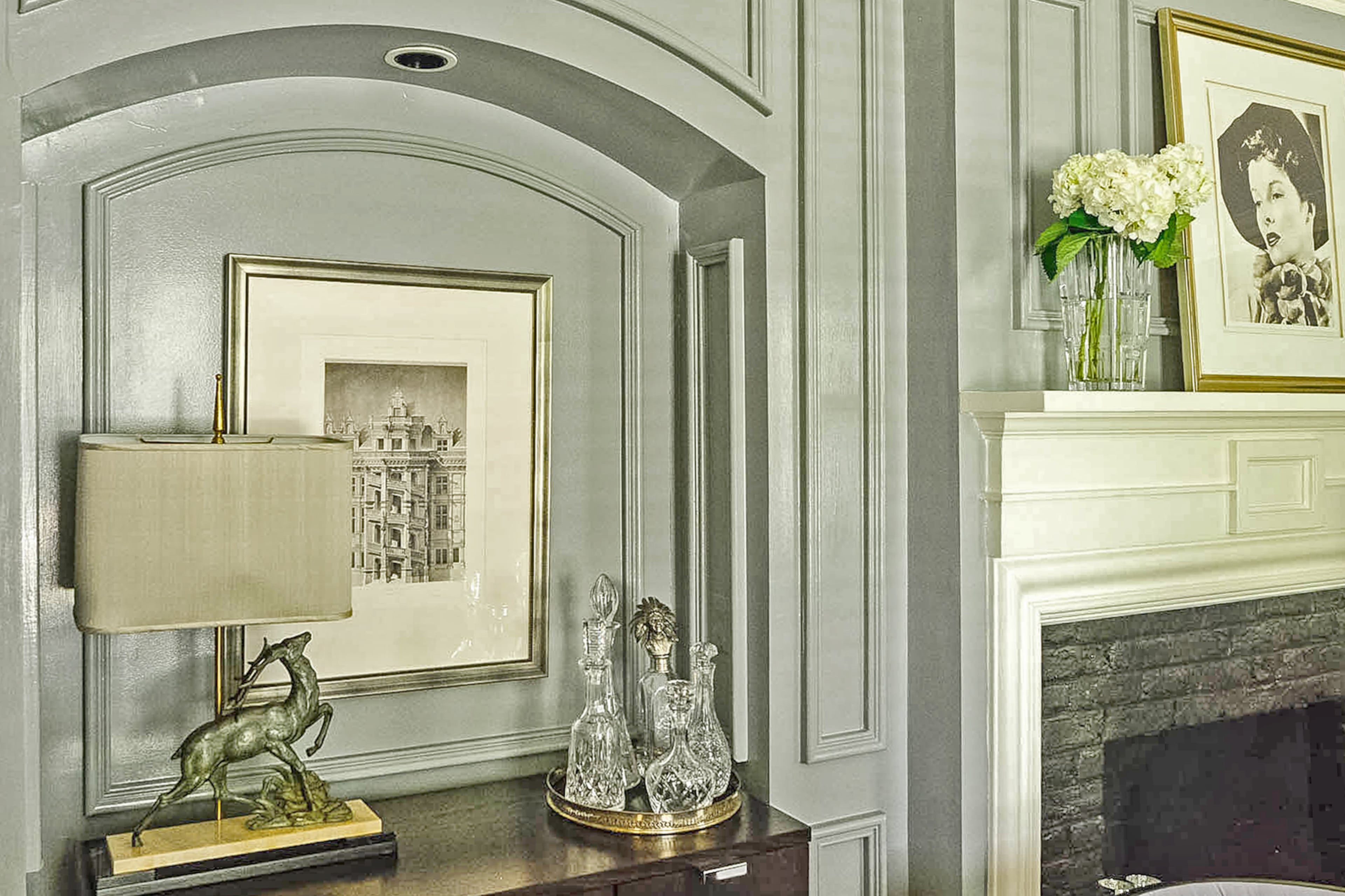 A niche with original millwork in the parlor features a photo of the royal chateau in Blois, located in France's Loire Valley.
