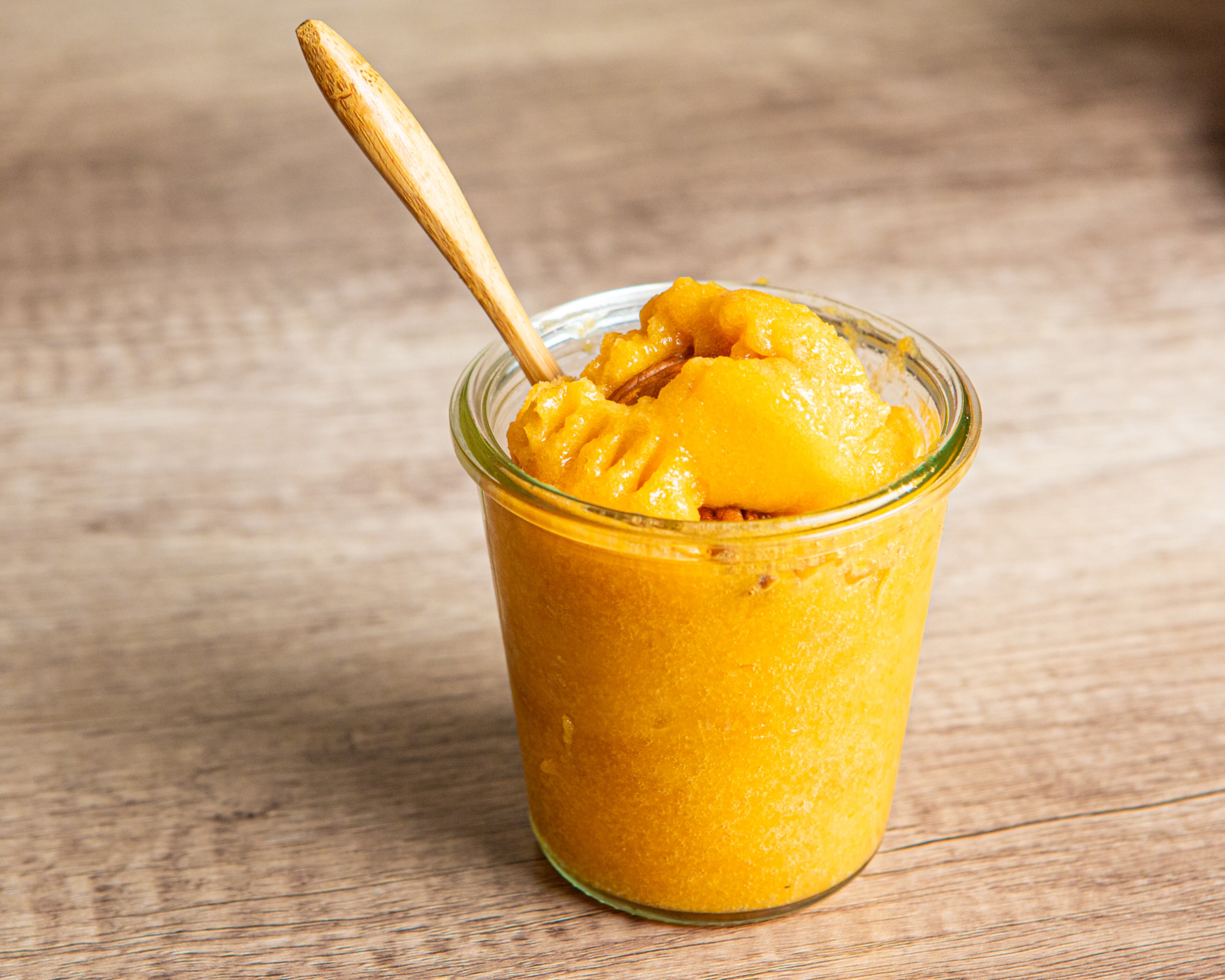 Freshly frozen peaches pair with buttery roasted pecans in this deliciously cool dessert. (Aaliyah Man for The AJC/Food styling by Jennifer Hill Booker.)