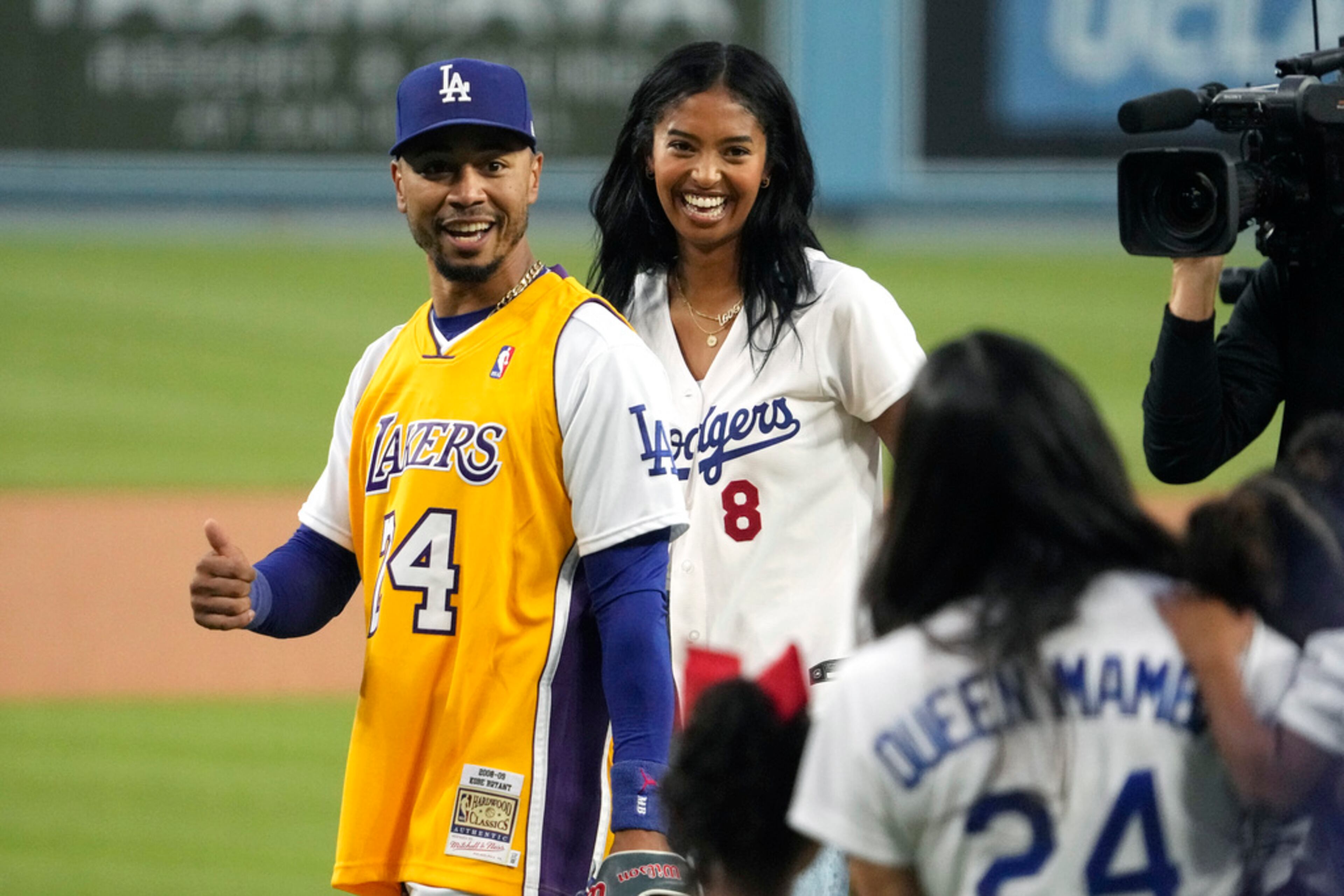 Los Angeles Dodgers right fielder Mookie Betts, left, gives a thumbs up to Vanessa Bryant, right, widow of Kobe Bryant, as Natalia Bryant, daughter of Kobe, looks on prior to a baseball game Friday, Sept. 1, 2023, in Los Angeles. Natalia threw out the ceremonial first pitch. (AP Photo/Mark J. Terrill)