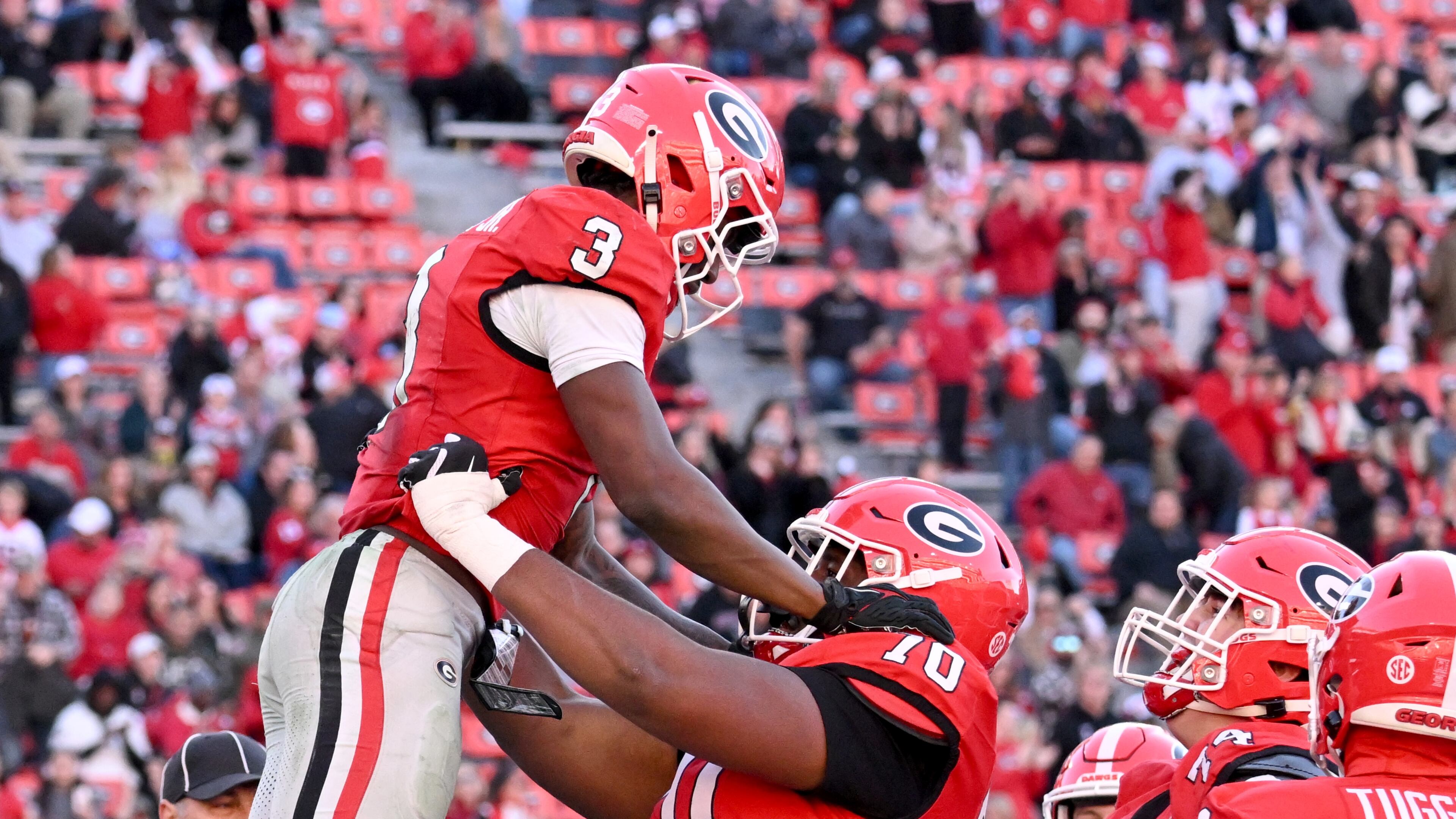 Georgia running back Nate Frazier (3) celebrates with Georgia offensive lineman Daniel Calhoun (70) after scoring a touchdown during the second half in an NCAA football game at Sanford Stadium, Saturday, November 23, 2024, in Athens. Georgia won 59-21 over UMass. (Hyosub Shin / AJC)