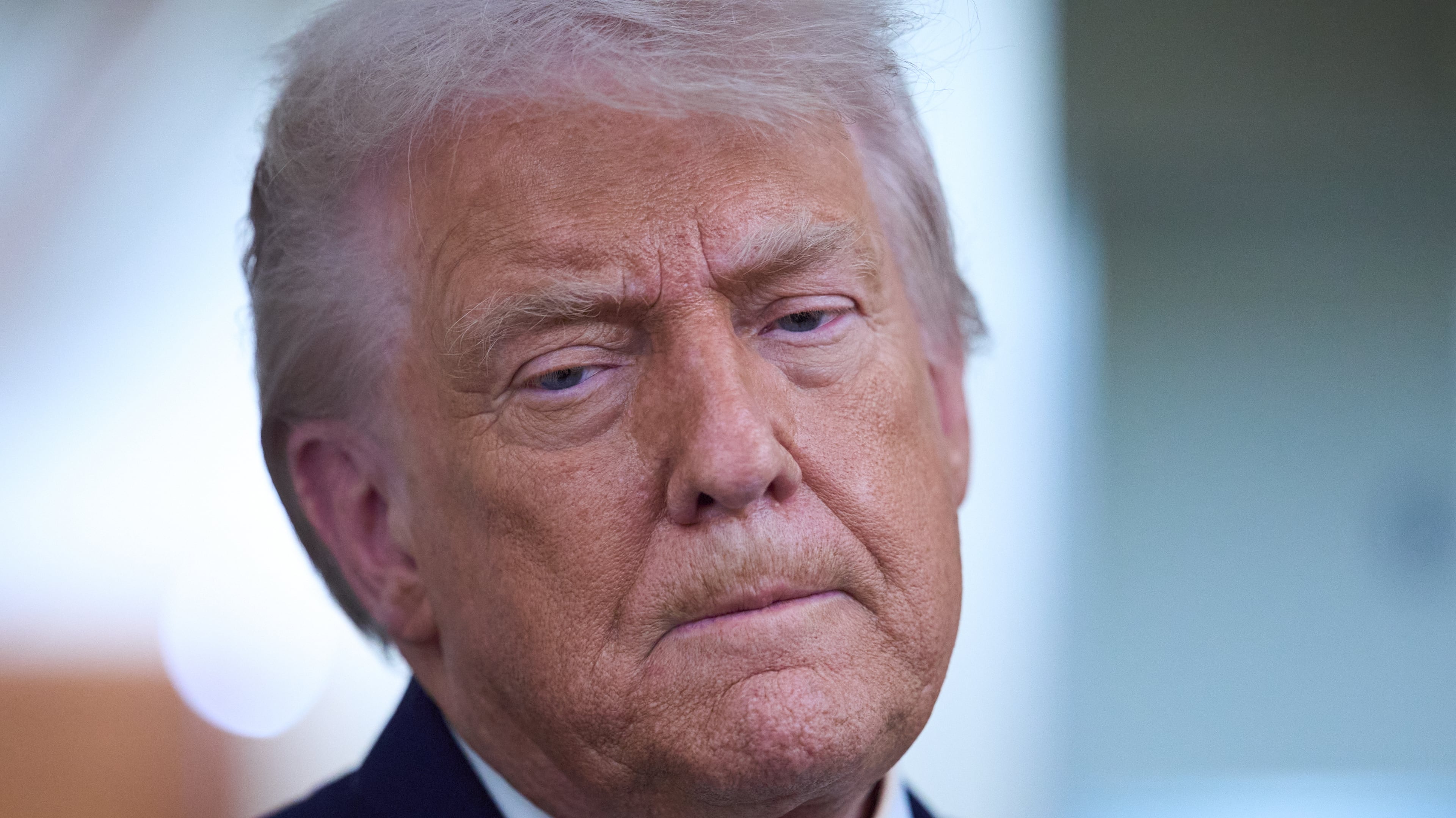 President Donald Trump speaks with reporters aboard Air Force One after leaving the World Economic Forum in Davos for Washington, Thursday, Jan. 22, 2026. (AP Photo/Evan Vucci)