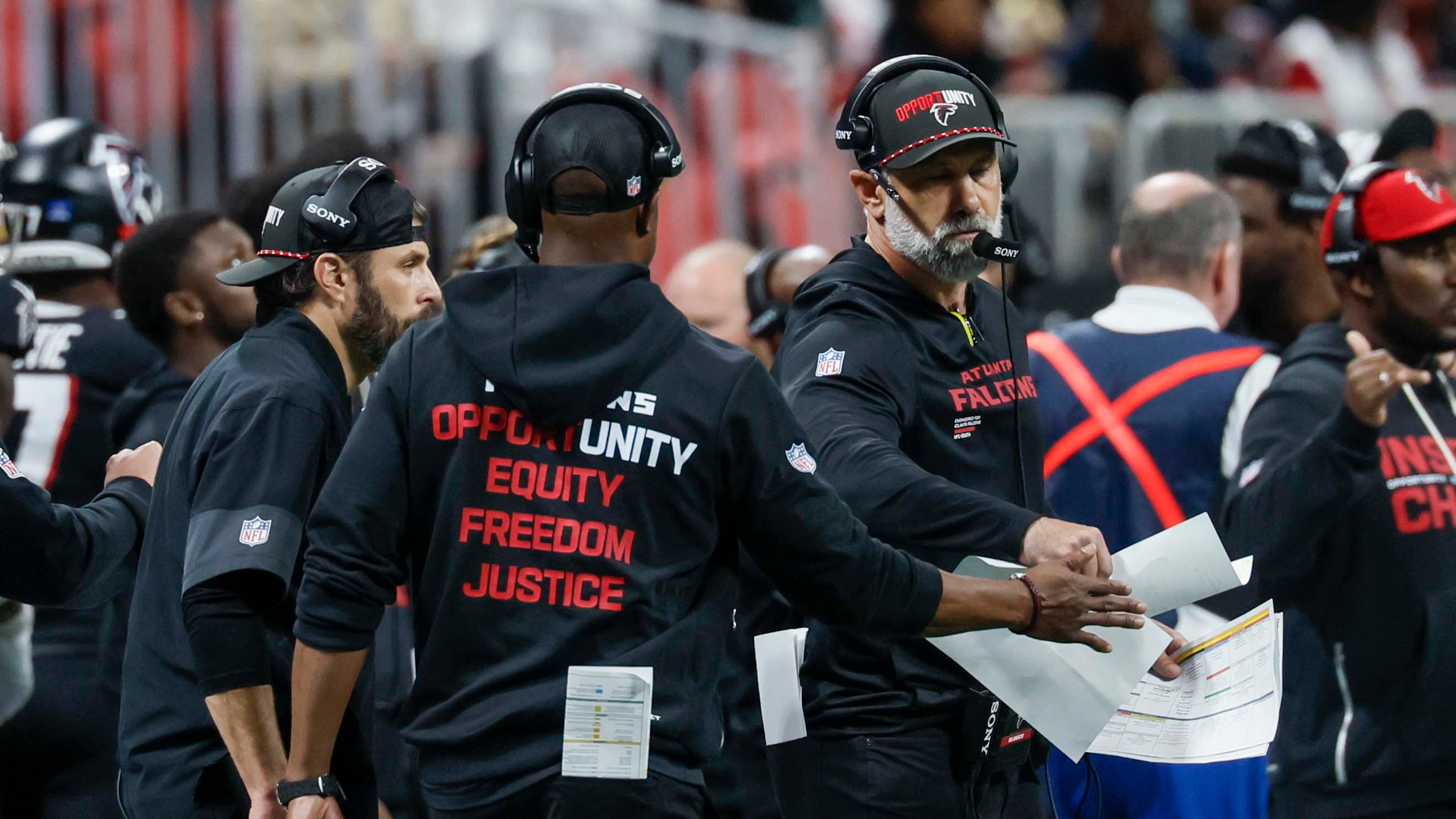 Falcons defensive coordinator Jeff Ulbrich (right) fist-bumps head coach Raheem Morris after a play during the second half against the Saints on Jan. 4, 2026. (Miguel Martinez/ AJC)