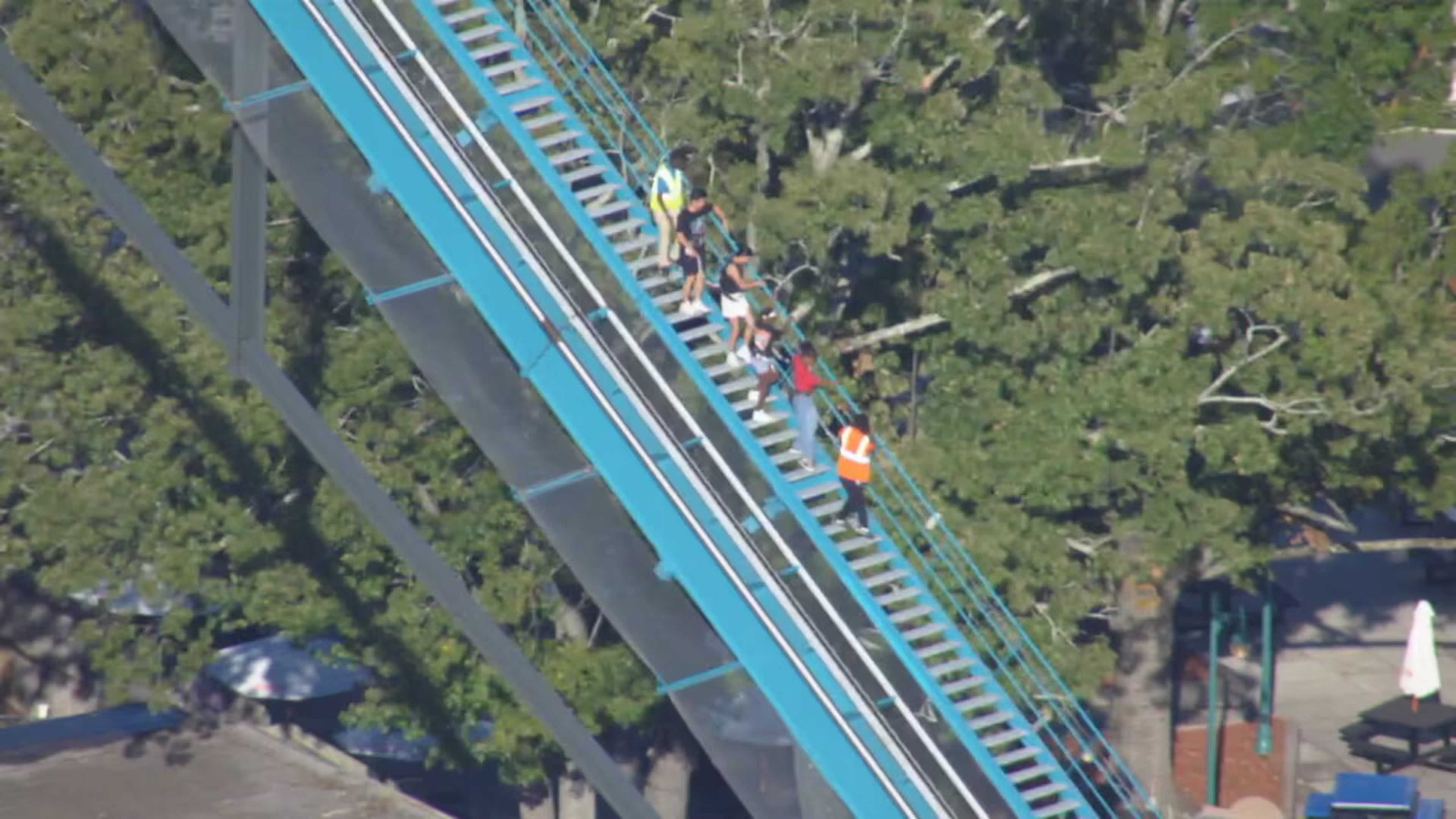 Riders on the Goliath roller coaster at Six Flags over Georgia in Austell are evacuated by park personnel on Monday, Oct. 12, 2026. One person died and several others were injured in “an incident involving a roller coaster” at Six Flags Over Georgia, Cobb County Police said Monday evening. (Courtesy WSB-TV)