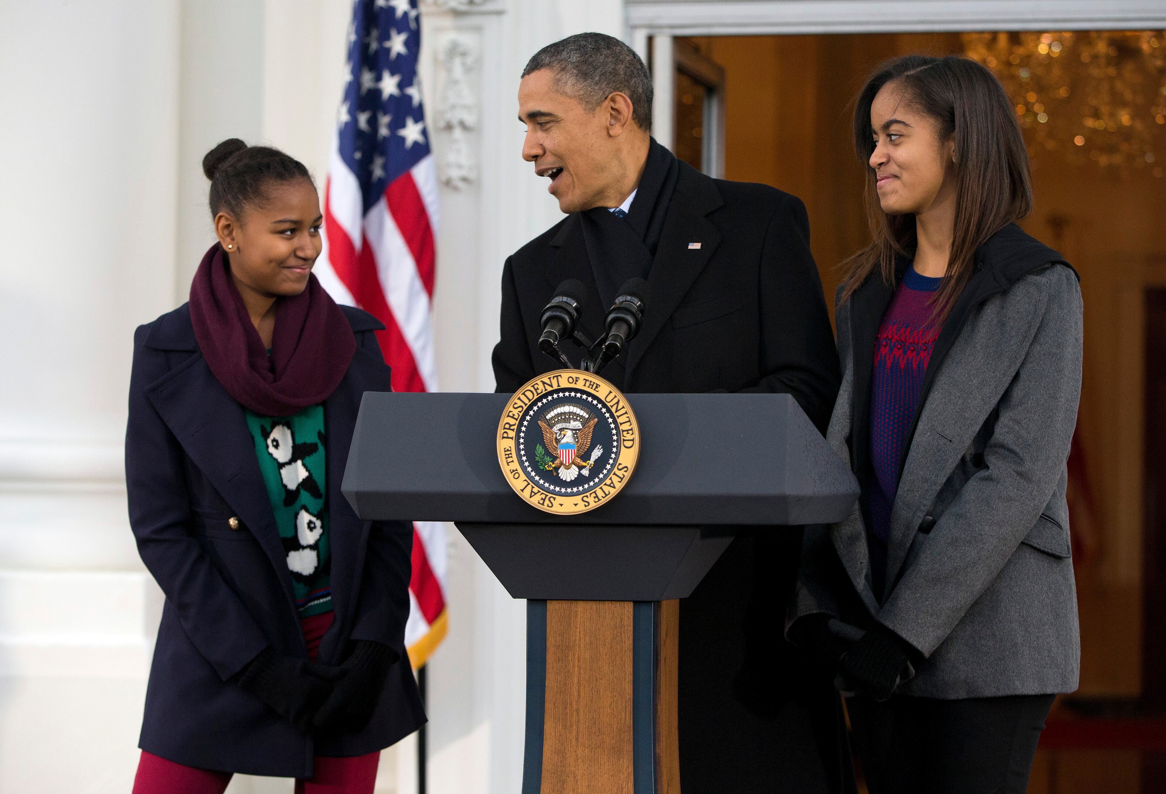 President Barack Obama, with daughters Sasha, left, and Malia, makes a joke during remarks at the Thanksgiving tradition of saving a turkey from the dinner table with a "presidential pardon" at the White House on Nov. 27, 2013, in Washington.