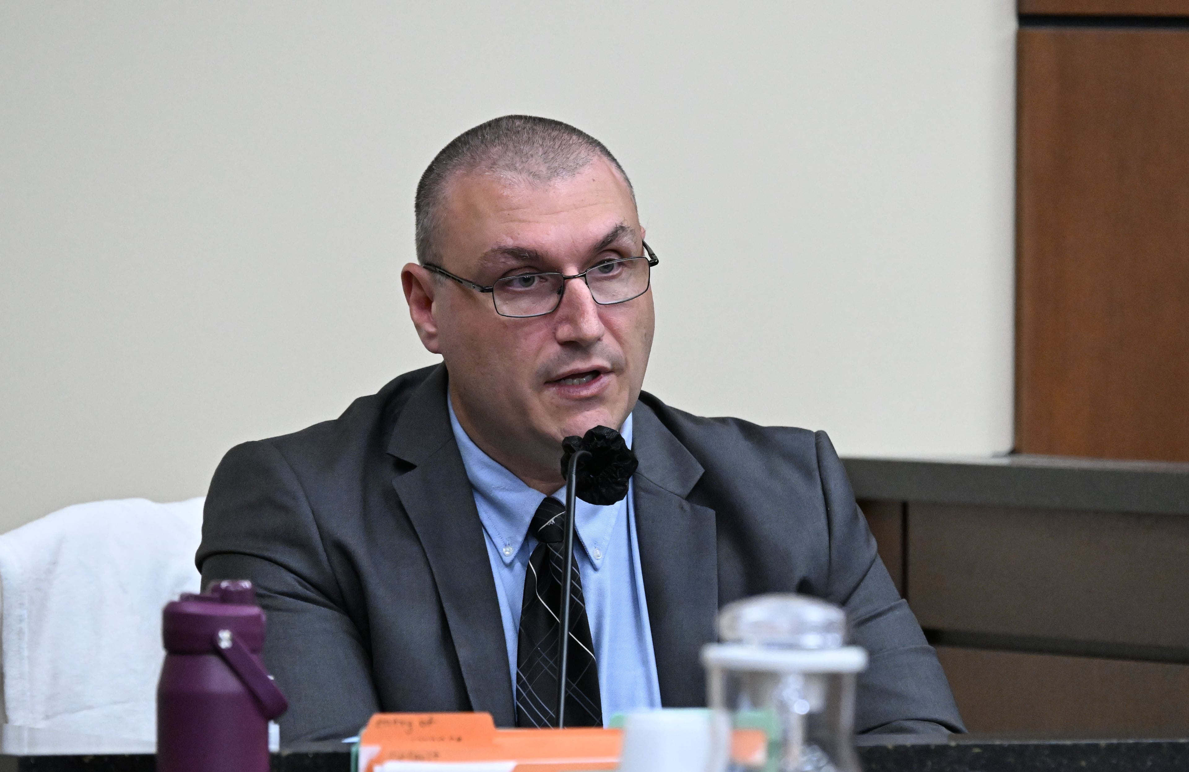 Smyrna police Detective Nathaniel Wachowiak testifies on the witness stand during a hearing for Kingston Bradley, who is charged with murder, at the Cobb County Magistrate Court on Friday, Oct. 23, 2026, in Marietta. (Hyosub Shin/AJC)
