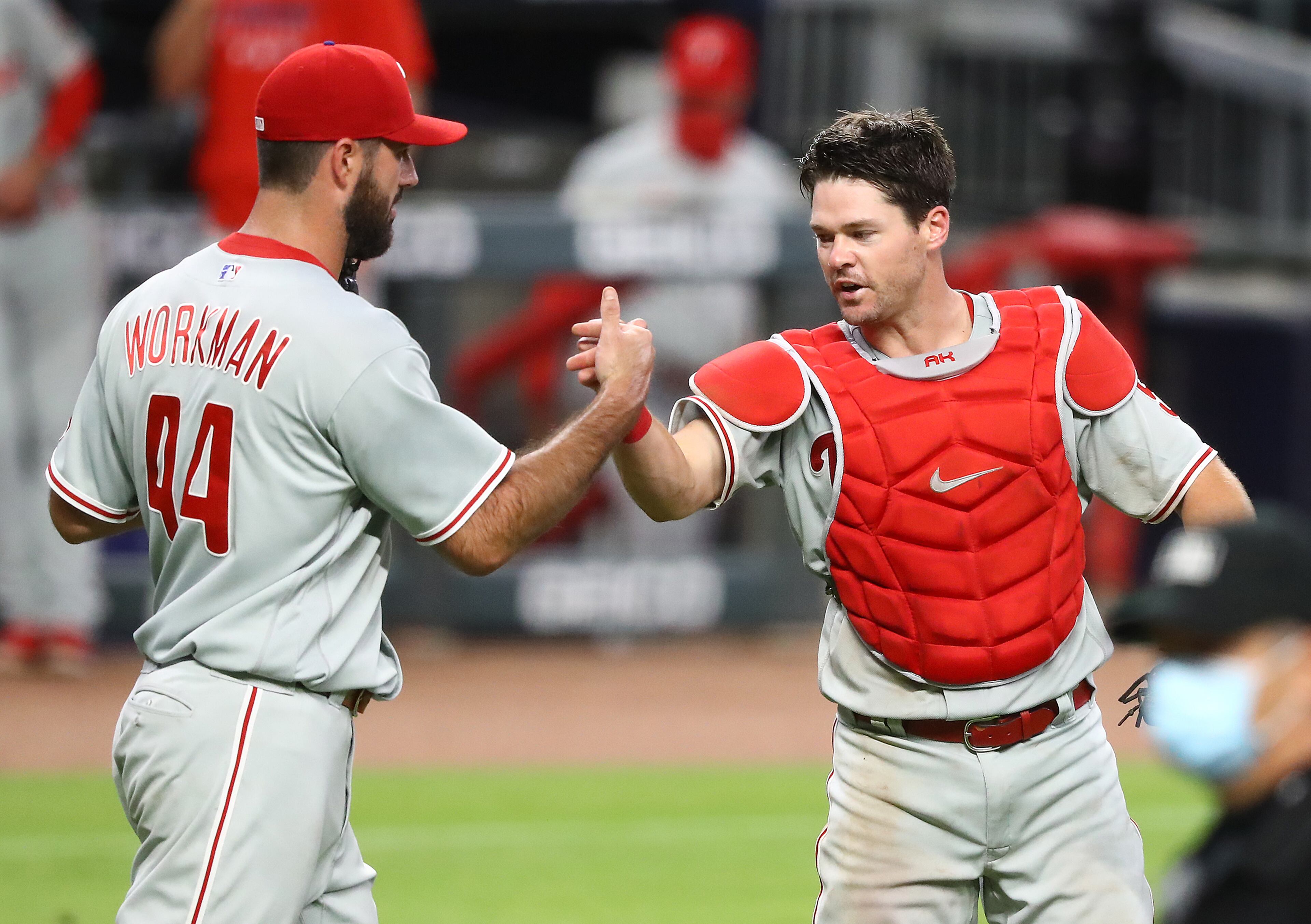 Philadelphia Phillies catcher Andrew Knapp and pitcher Brandon Workman celebrate a 5-4 victory over the Atlanta Braves during the ninth inning in a MLB baseball game on Sunday, August 23, 2020 in Atlanta. Curtis Compton ccompton@ajc.com