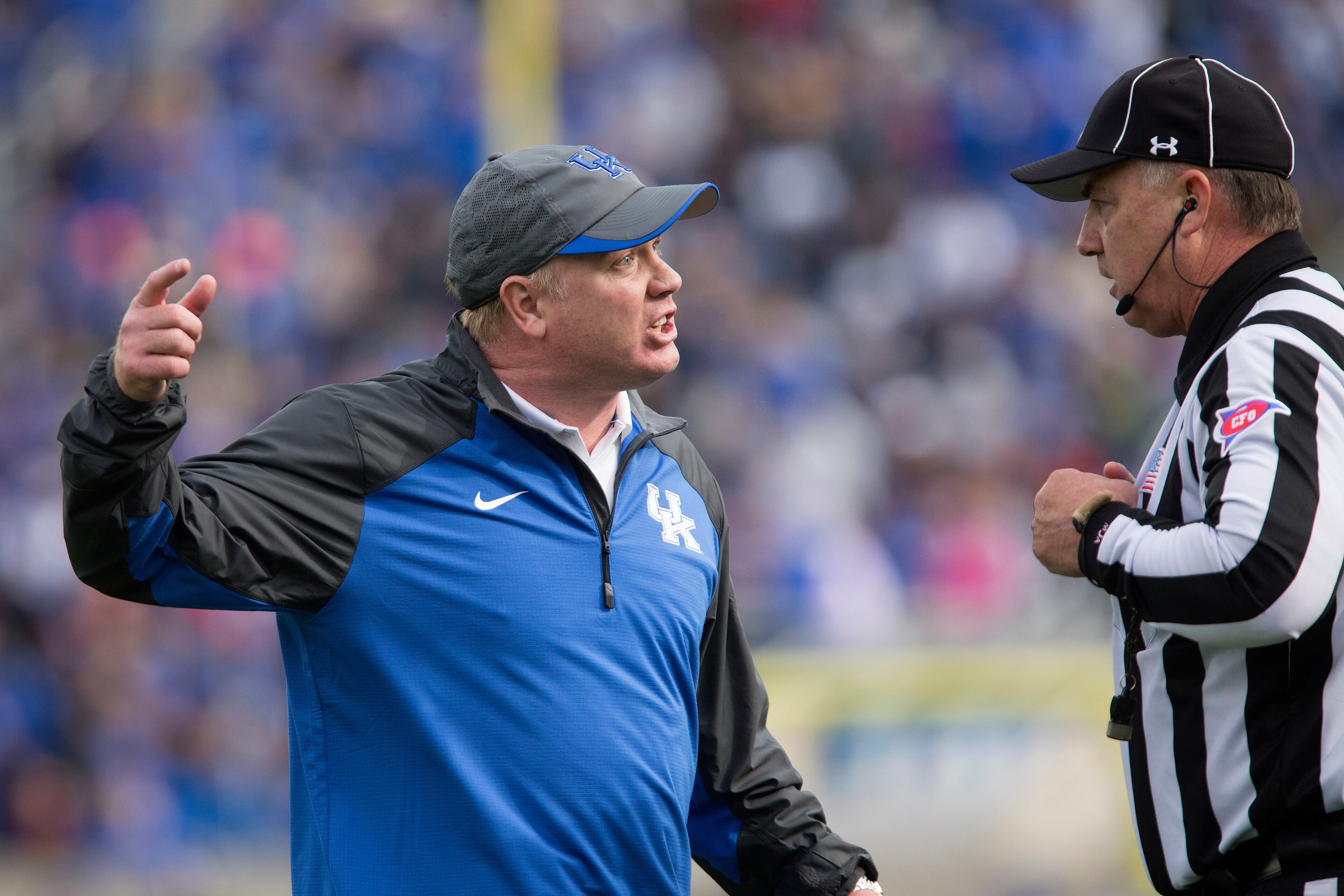 Kentucky head coach Mark Stoops argues with an official about a call during the first half of an NCAA college football game against Georgia at Commonwealth Stadium in Lexington, Ky., Saturday, Nov. 8, 2014. (AP Photo/David Stephenson)