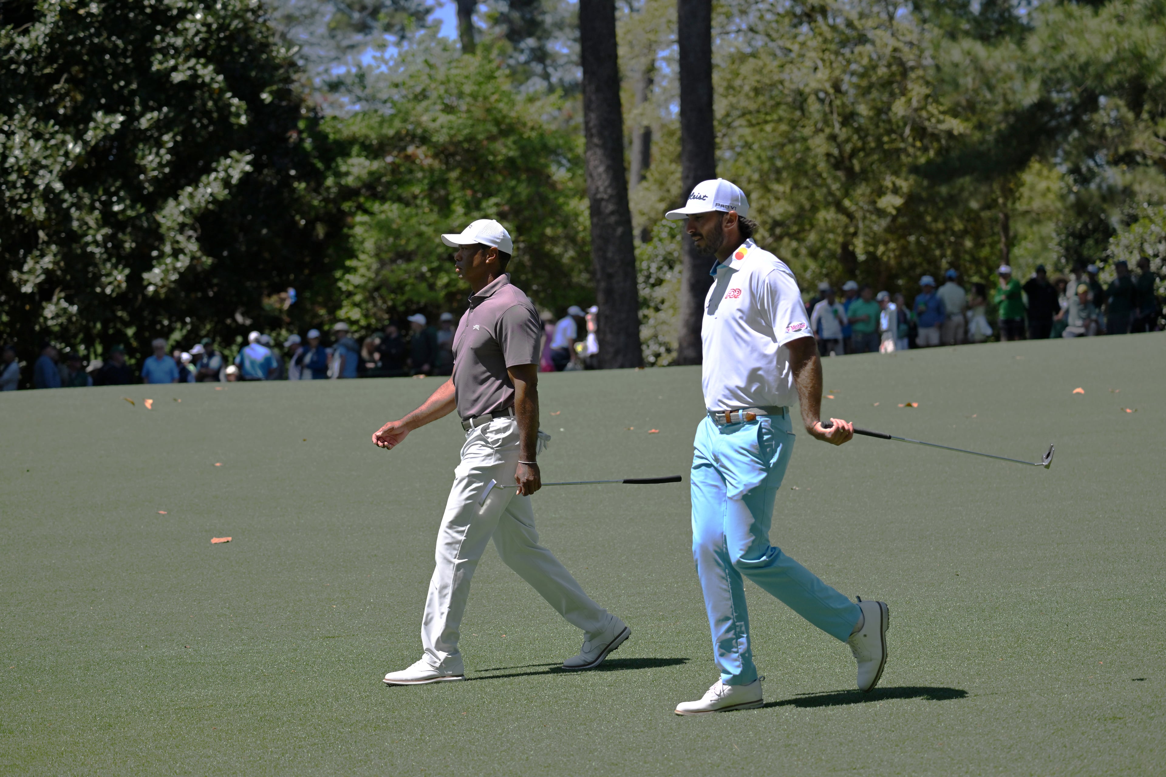 Tiger Woods and Max Homa walk down the 10th fairway during second round of the 2024 Masters Tournament at Augusta National Golf Club, Friday, April 12, 2024, in Augusta, Ga. (Hyosub Shin / Hyosub.Shin@ajc.com)
