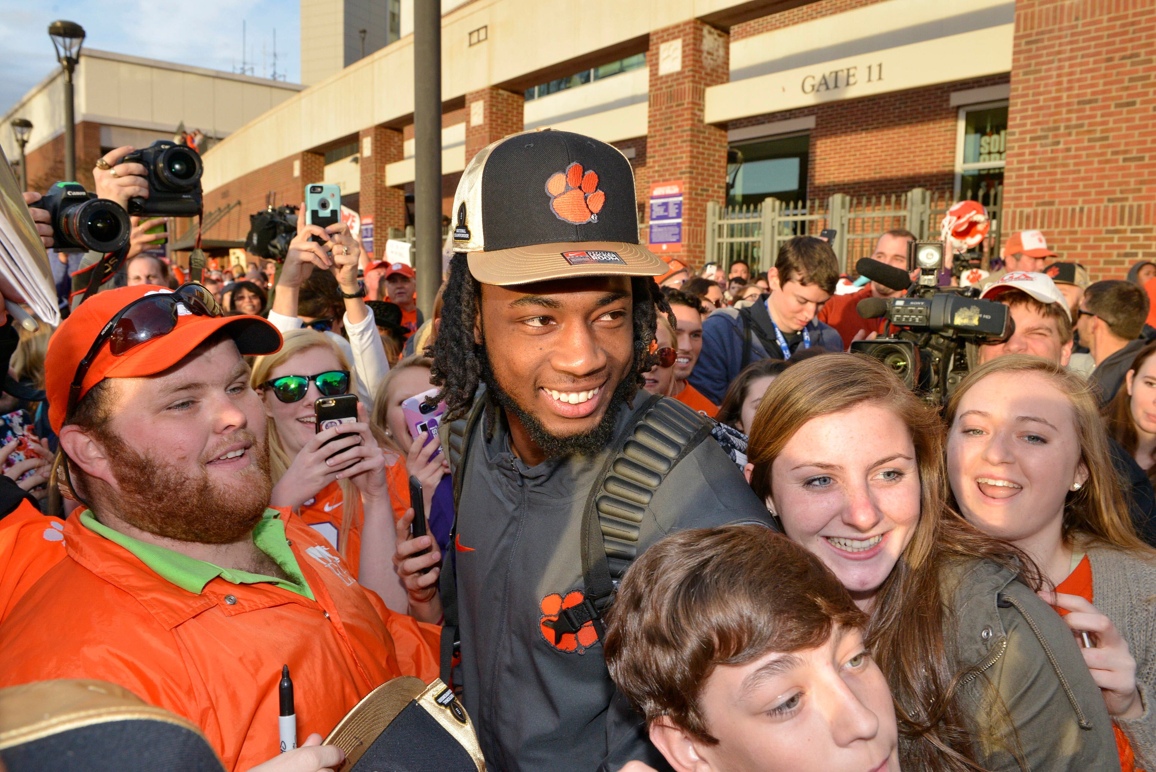 Clemson's Mike Williams poses for photos with fans Tuesday, Jan. 10, 2017, in Clemson, S.C., the day after the Tigers defeated Alabama 35-31 in the College Football Playoff championship NCAA college football game in Tampa. (AP Photo/Richard Shiro)