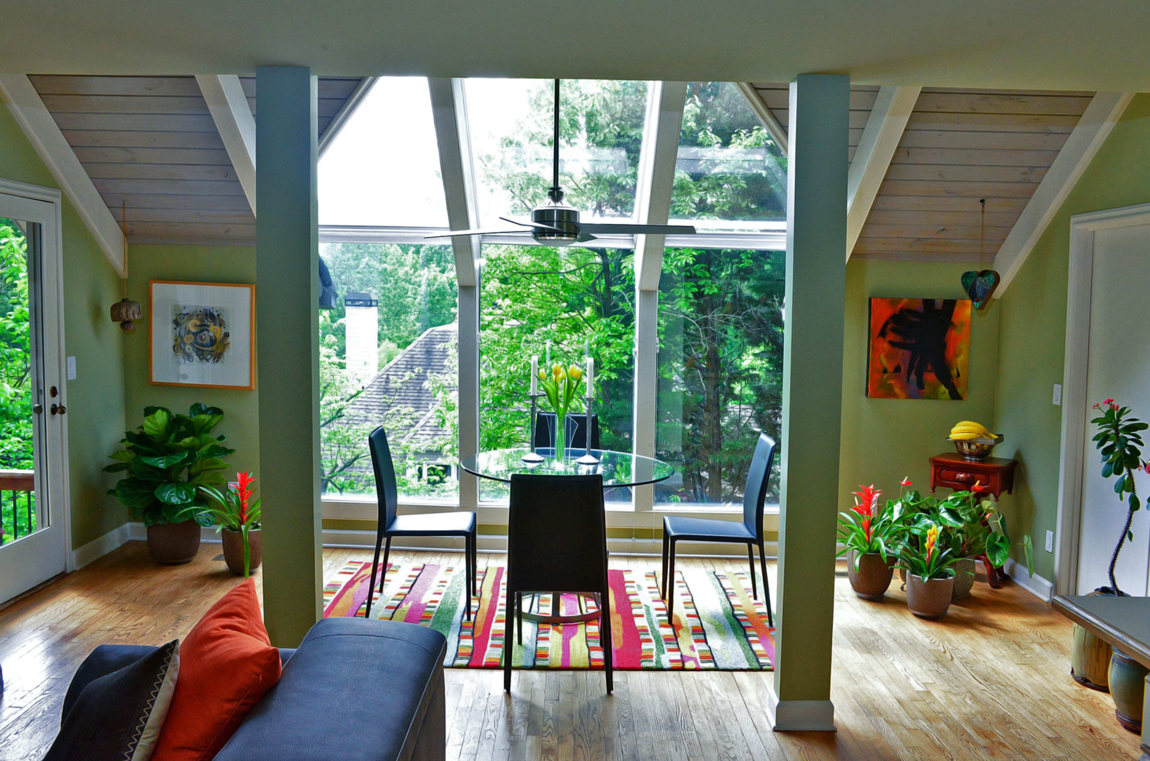Natural light floods Randy Urquhart's and Judy Mozen's home in nearly every room. The breakfast area just off the kitchen features a wall of fixed windows that reach to the vaulted ceiling. Because of the sunlight, Mozen's beloved plants thrive throughout the house.