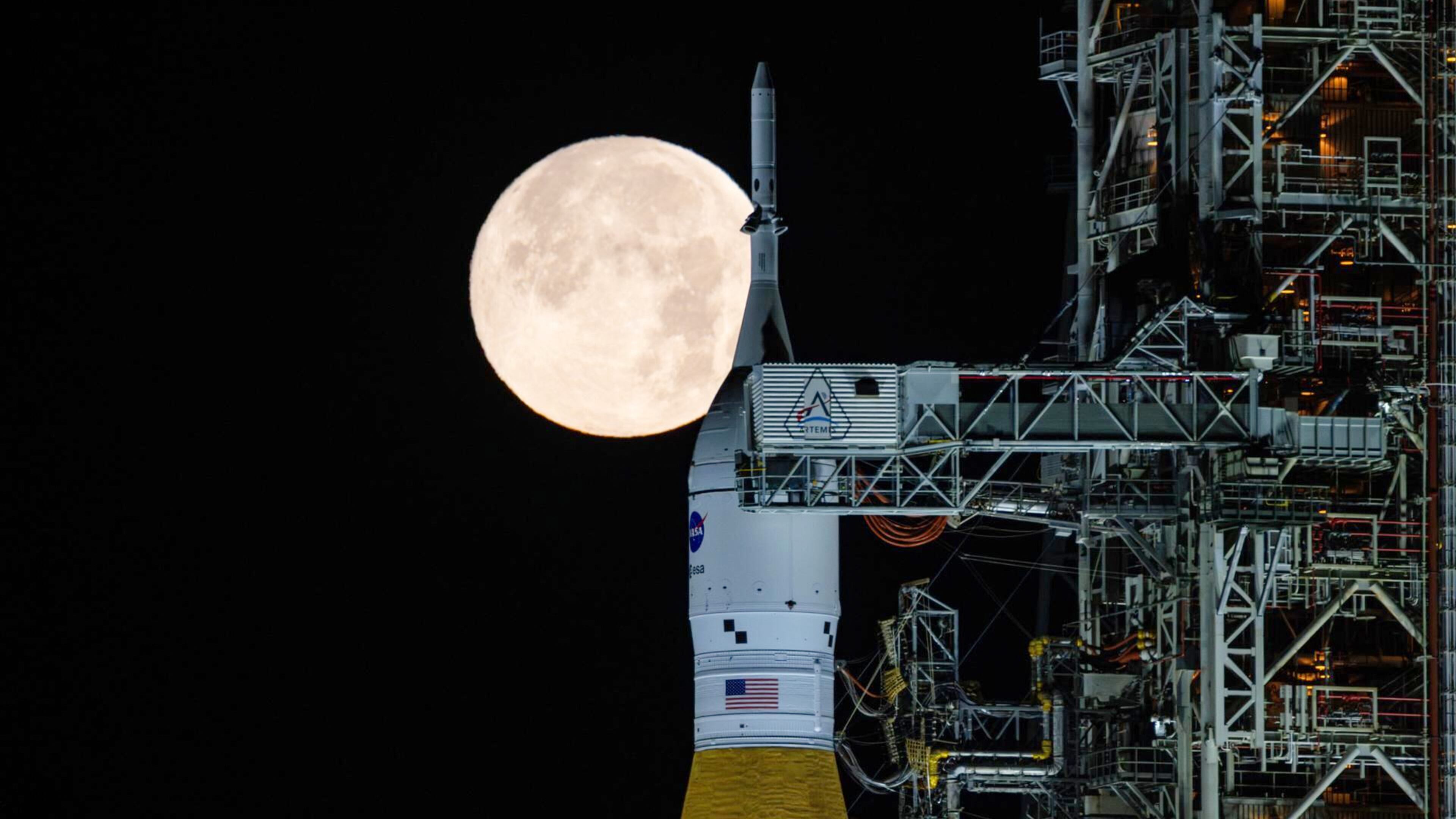 A full moon is seen shining over NASA’s SLS (Space Launch System) and Orion spacecraft, atop the mobile launcher in the early hours of Sunday, Feb. 1, 2026, at NASA’s Kennedy Space Center in Florida. (Sam Lott/NASA via AP)