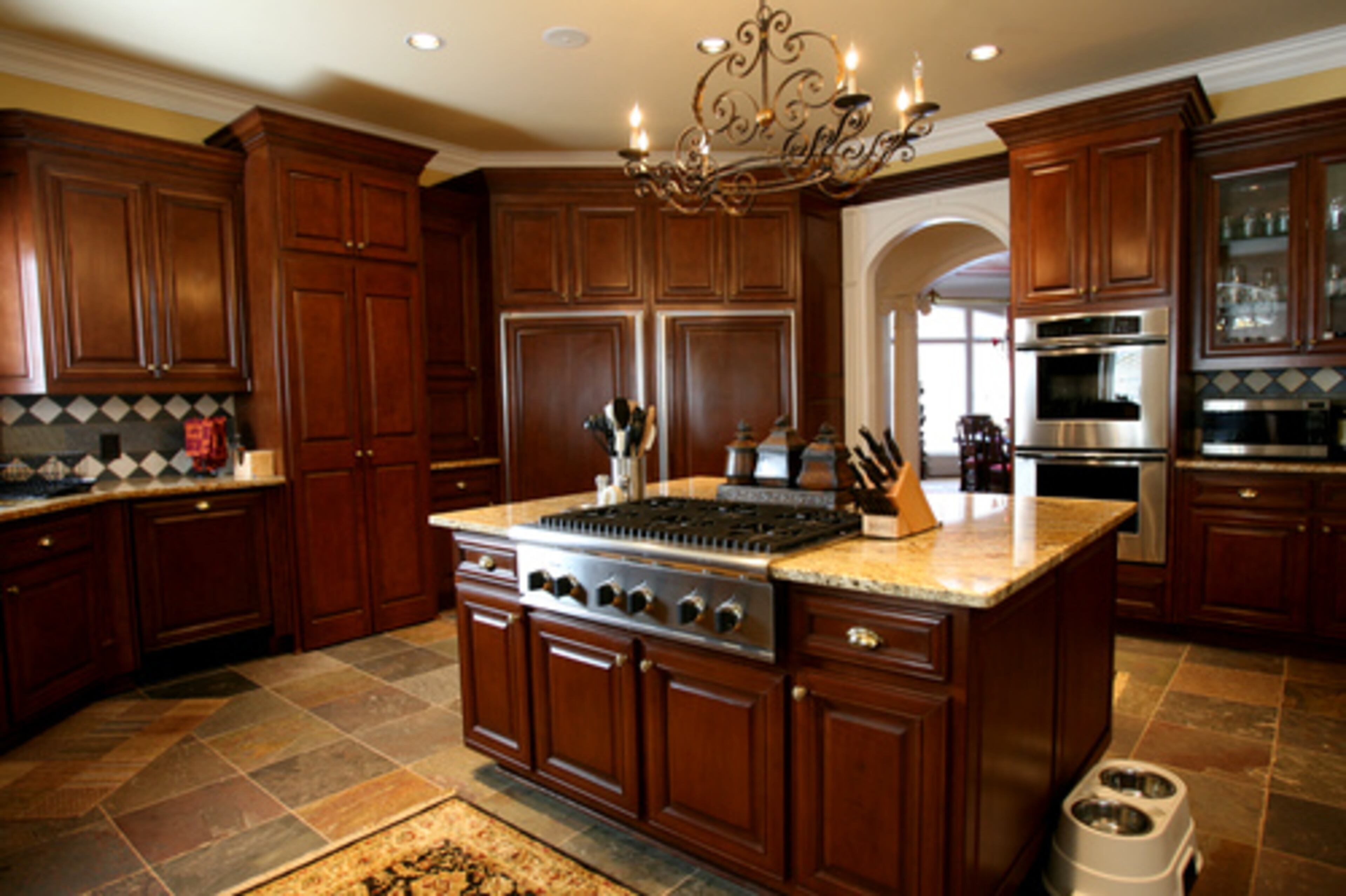 The Roberson's kitchen features a large island, a double refrigerator and a slate floor. When the couple started looking at homes, Marian decided she needed another warming drawer in her new kitchen. (This kitchen has two.)