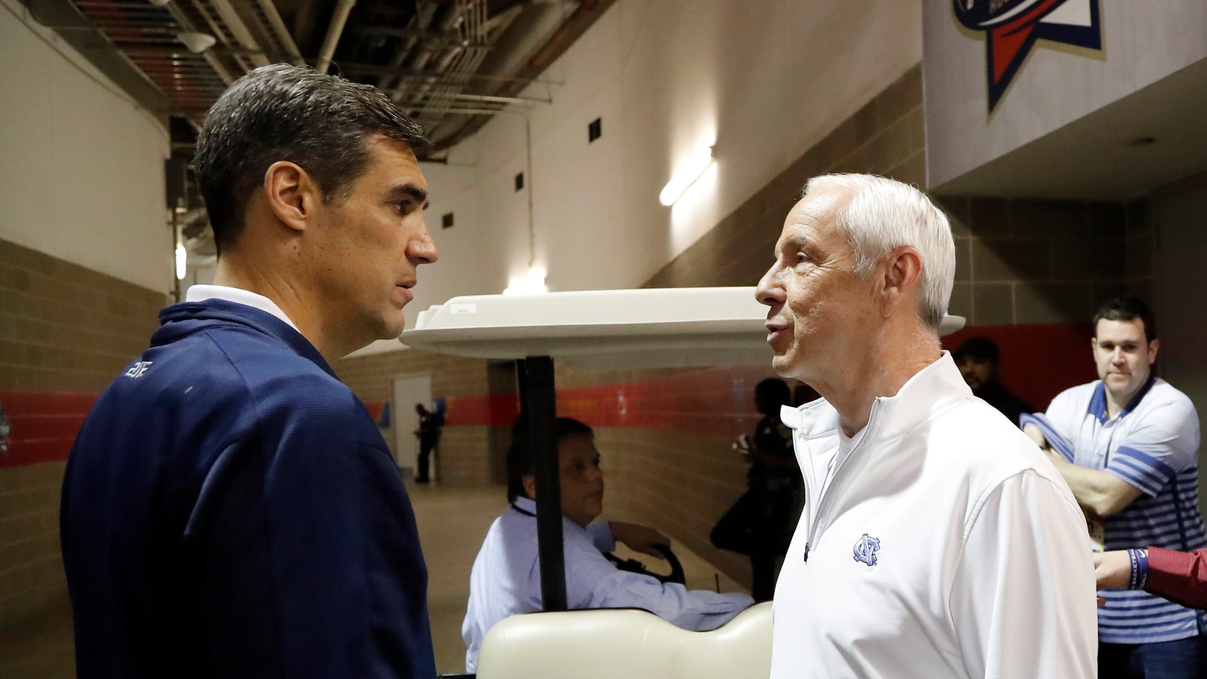 Villanova head coach Jay Wright, left, and North Carolina head coach Roy Williams talk after a CBS Sports Network interview for the NCAA Final Four tournament college basketball championship game Sunday, April 3, 2016, in Houston. Villanova and North Carolina will play in the championship game on Monday. (AP Photo/David J. Phillip)