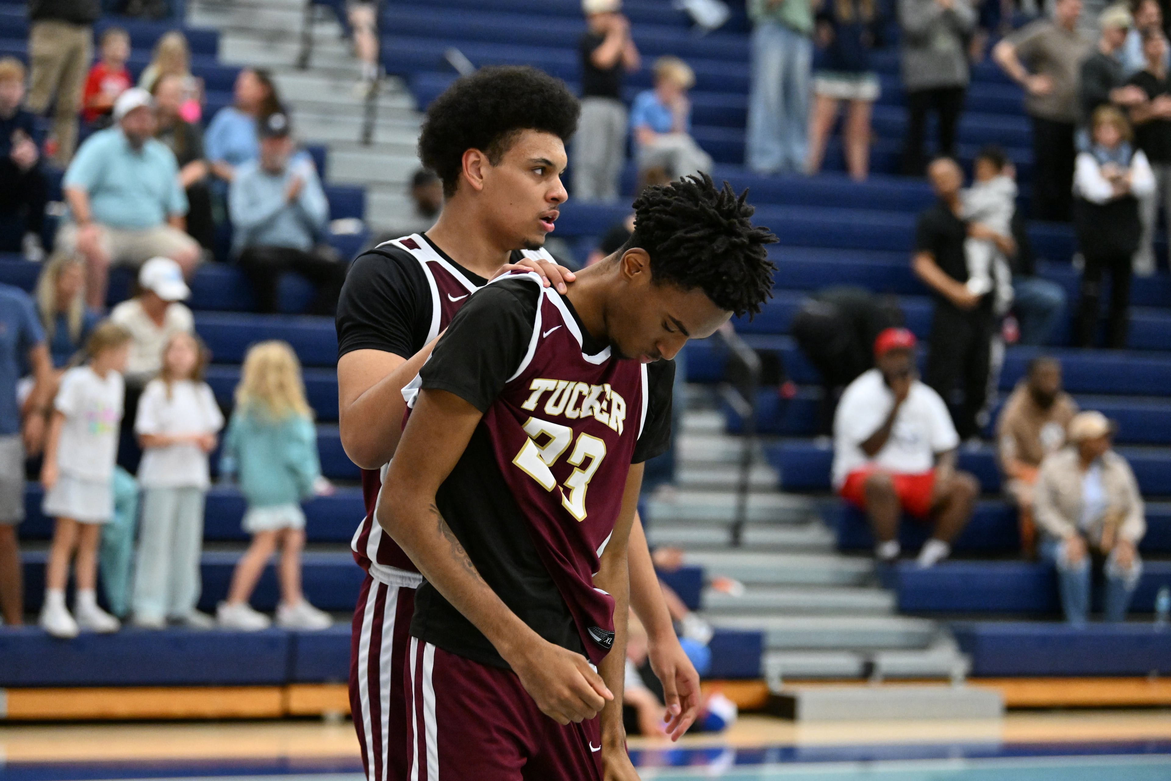 Tucker players lament their loss to Cambridge, 58-56, Saturday. (Hyosub Shin/AJC)