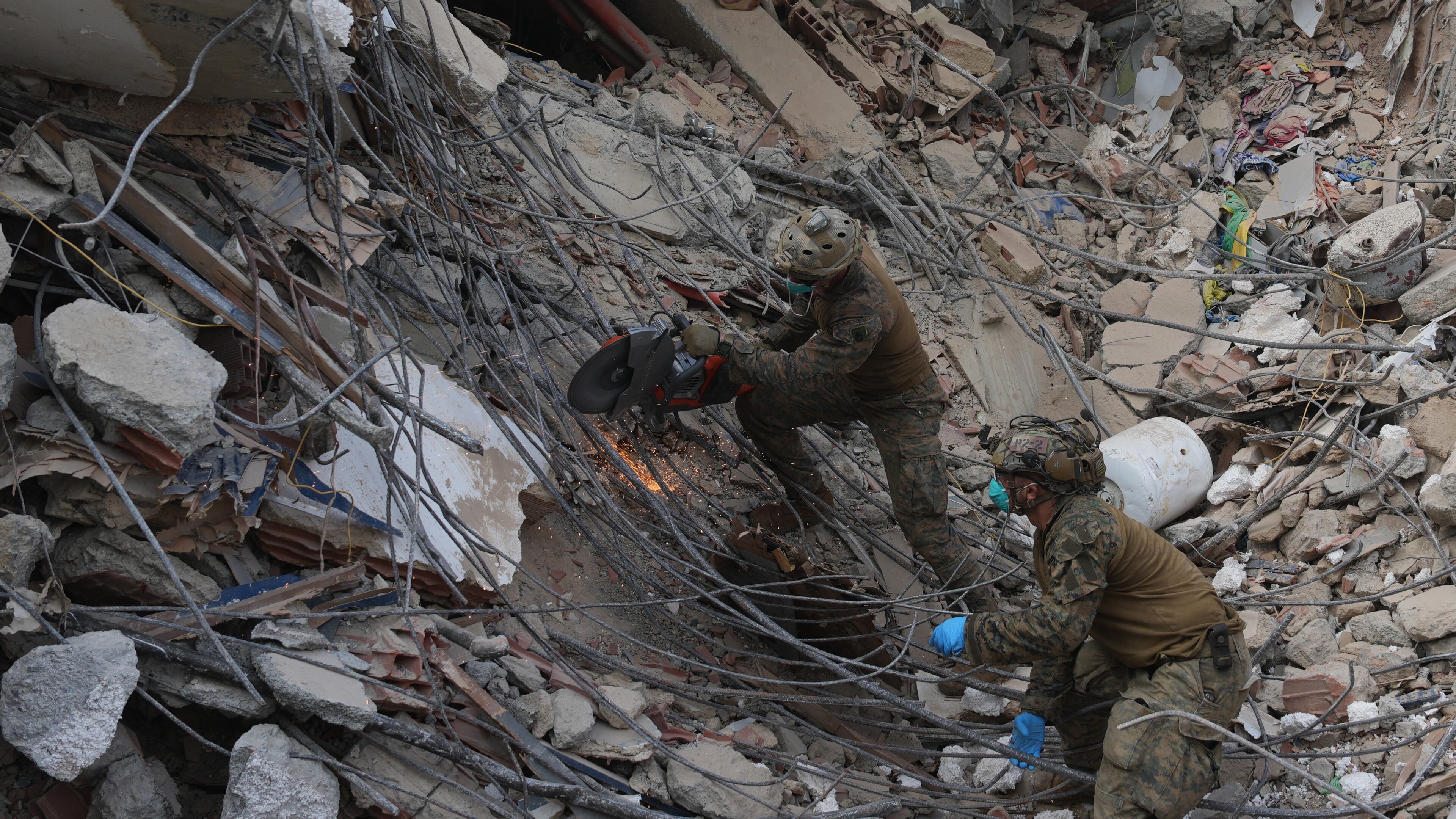 U.S. troops cut through rebar while clearing rubble during a search at a building that collapsed in the twin earthquakes in La Guaira, Venezuela, Tuesday, June 30, 2026. (AP Photo/Ariana Cubillos)