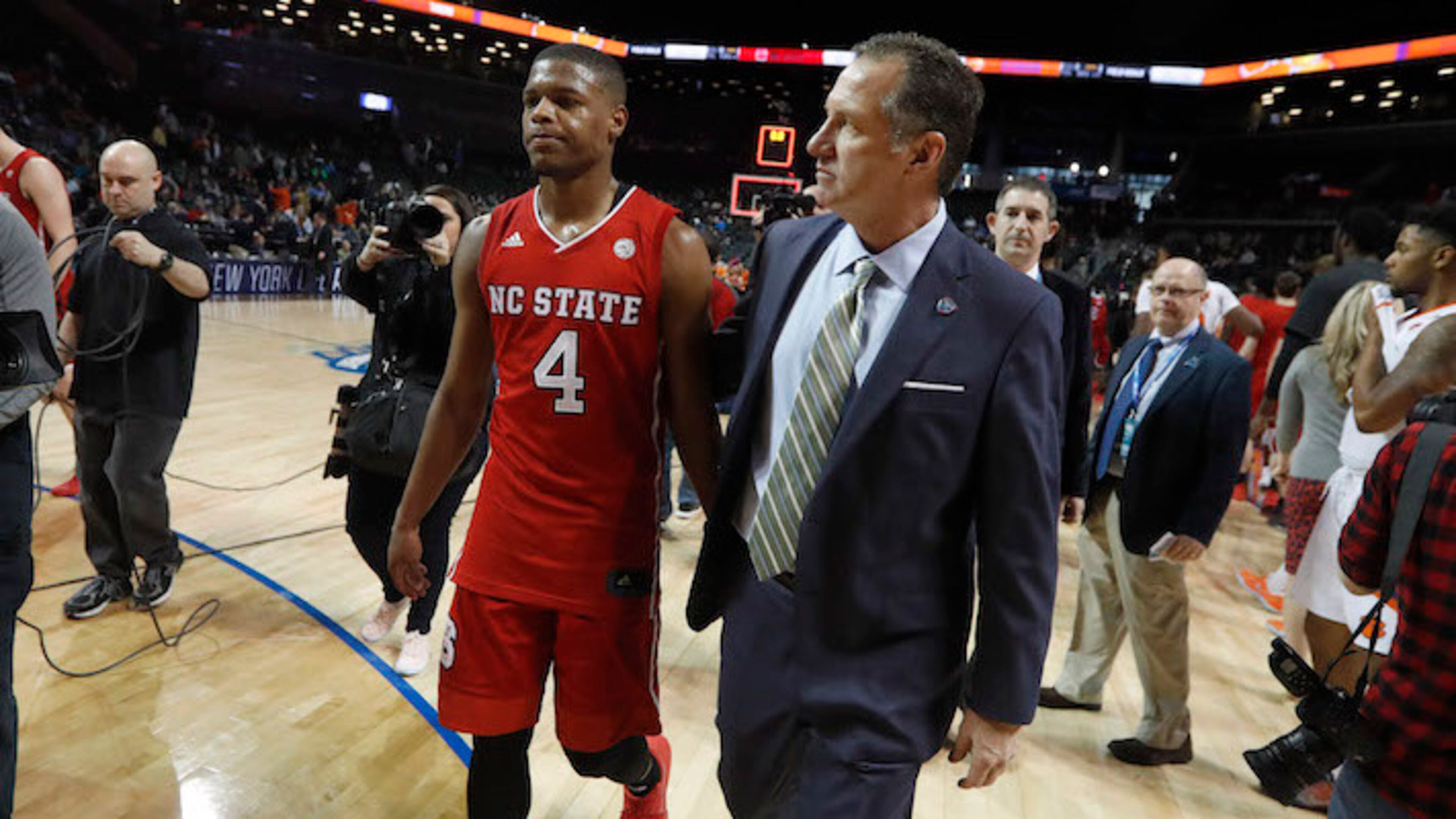 North Carolina State head coach Mark Gottfried walks off the floor with Dennis Smith Jr. (4) after a 75-61 loss against Clemson in the first round of the ACC Tournament at the Barclays Center in Brooklyn, N.Y., on March 7, 2017. (Ethan Hyman/Raleigh News & Observer/TNS)