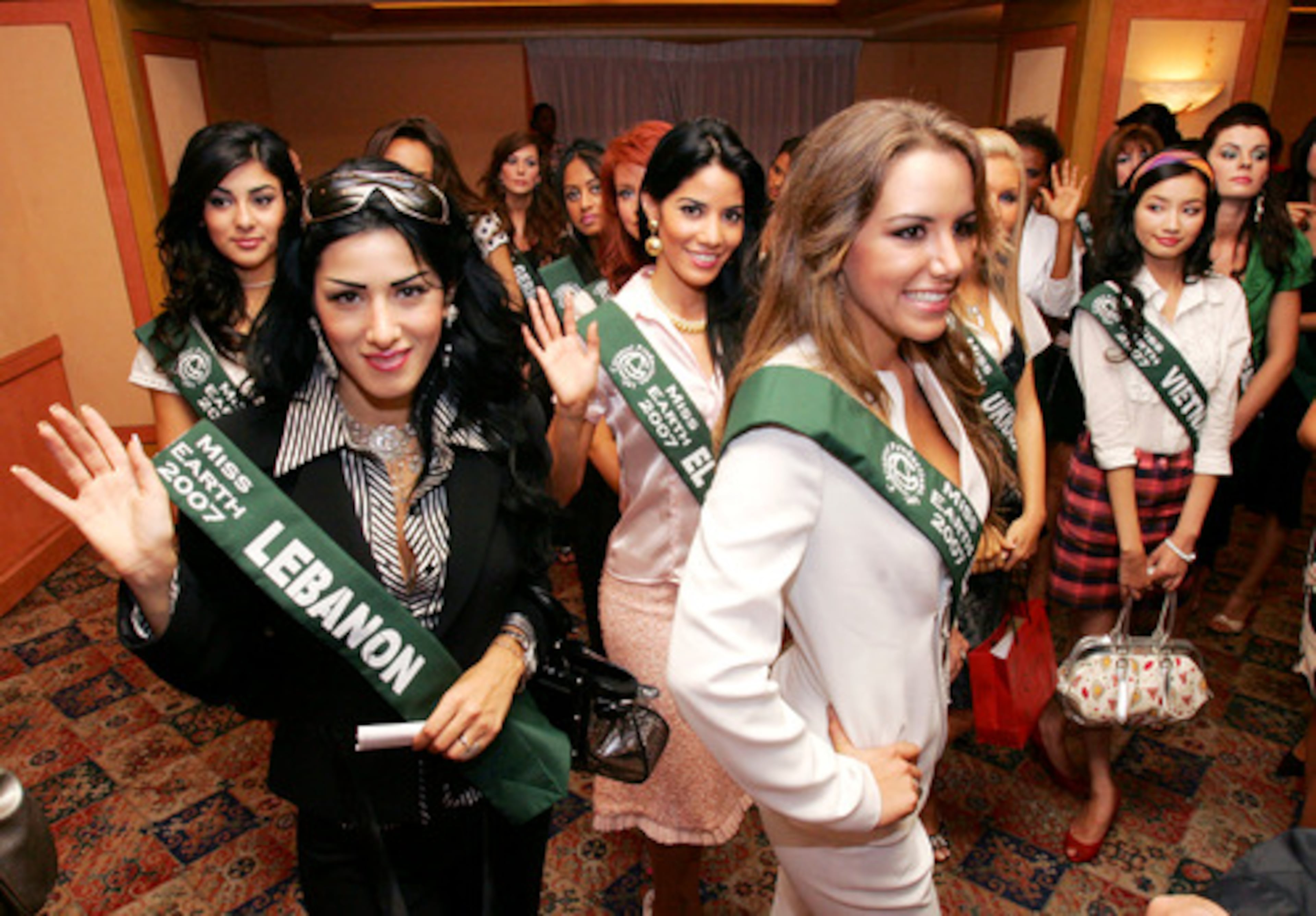 Miss Georgia Nana Mamasakhlisi, left, Miss Lebanon Amale Alkhoder, 2nd left, Miss El Salvador Julia Ayala, 3rd left, Miss Ecuador Veronica Ochoa Crespo, 3rd right, Miss Eukraine Galyna Andreeva, 2nd right, Miss Vietnam Truong Truc Diem, right, together with some of the contestants for the Miss Earth 2007 beauty pageant.