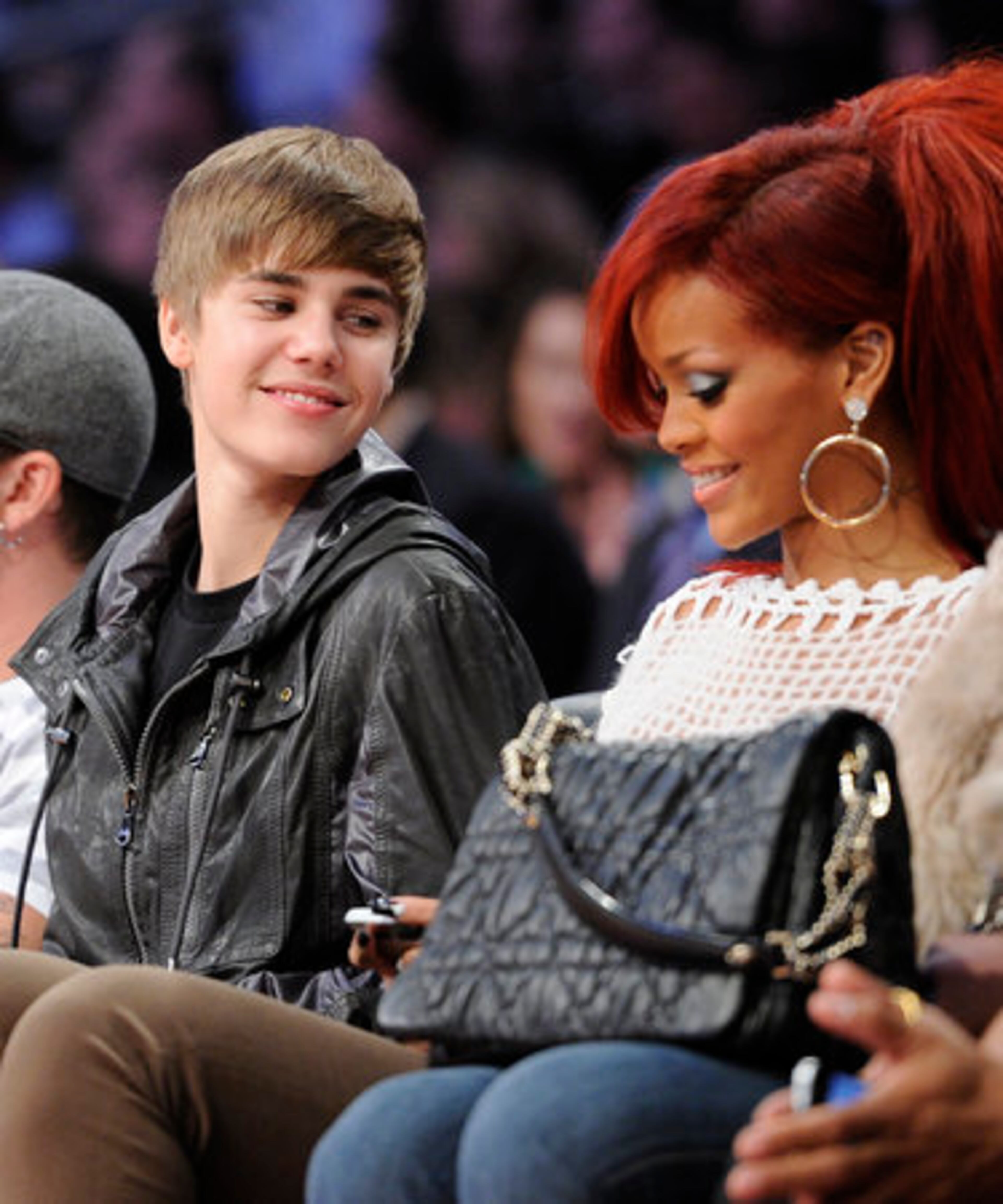 Justin Bieber talks to Rihanna during the second half of the NBA basketball All-Star Game.