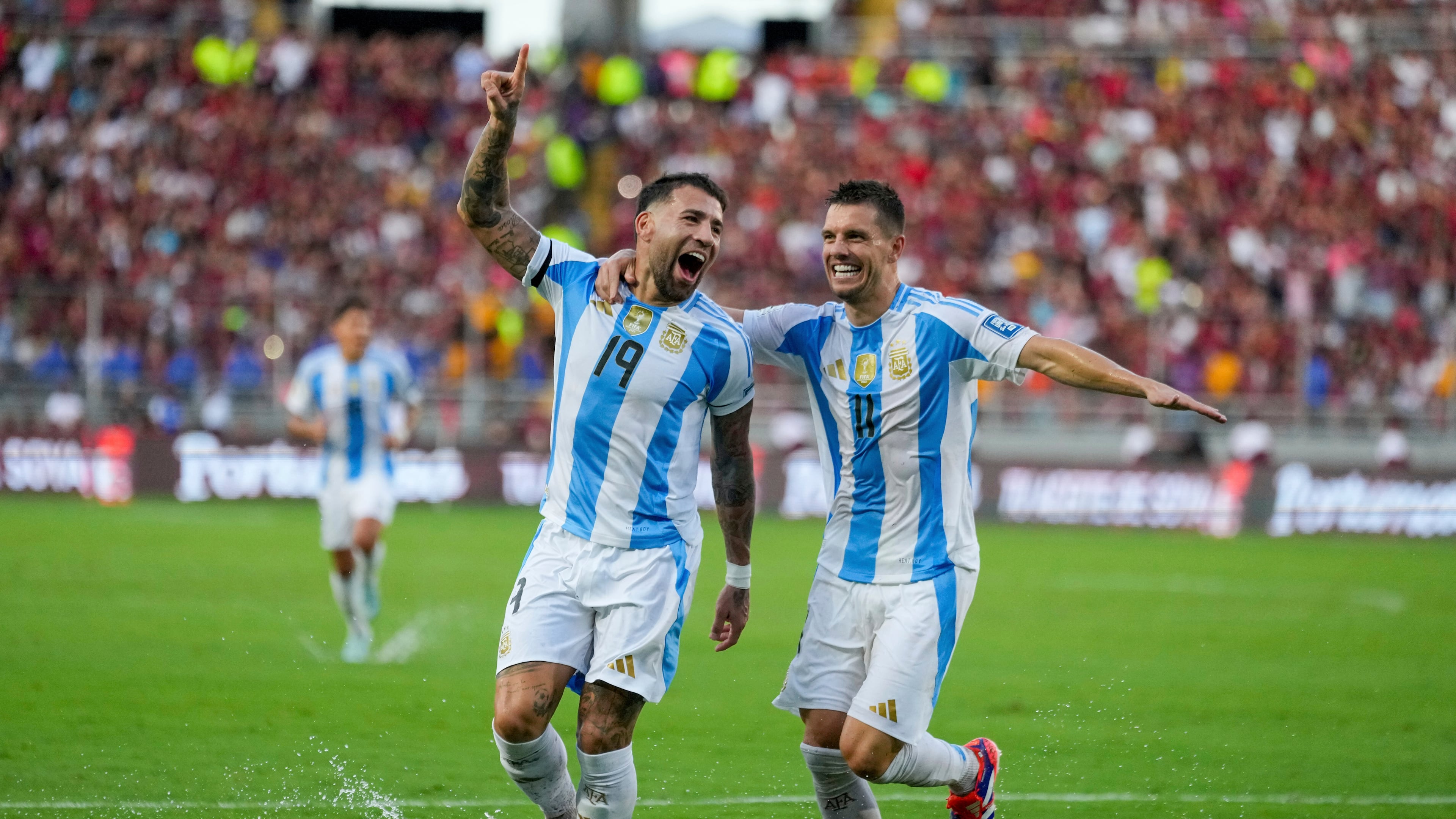 FILE - Argentina's Nicolas Otamendi (19, File) celebrates with Giovani Lo Celso after scoring his side's opening goal against Venezuela during a FIFA World Cup 2026 qualifying soccer match in Maturin, Venezuela, Thursday, Oct. 10, 2024. (AP Photo/Ariana Cubillos, File)