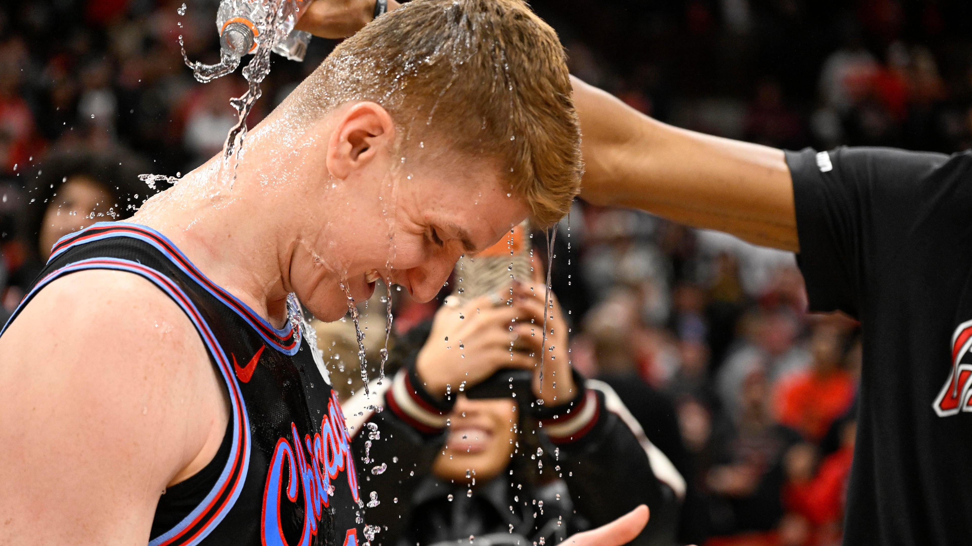 Chicago Bulls guard Kevin Huerter gets doused with water after an NBA basketball game against the Boston Celtics, Saturday, Jan. 24, 2026, in Chicago. Huerter scored the game winning three-point basket. (AP Photo/Matt Marton)