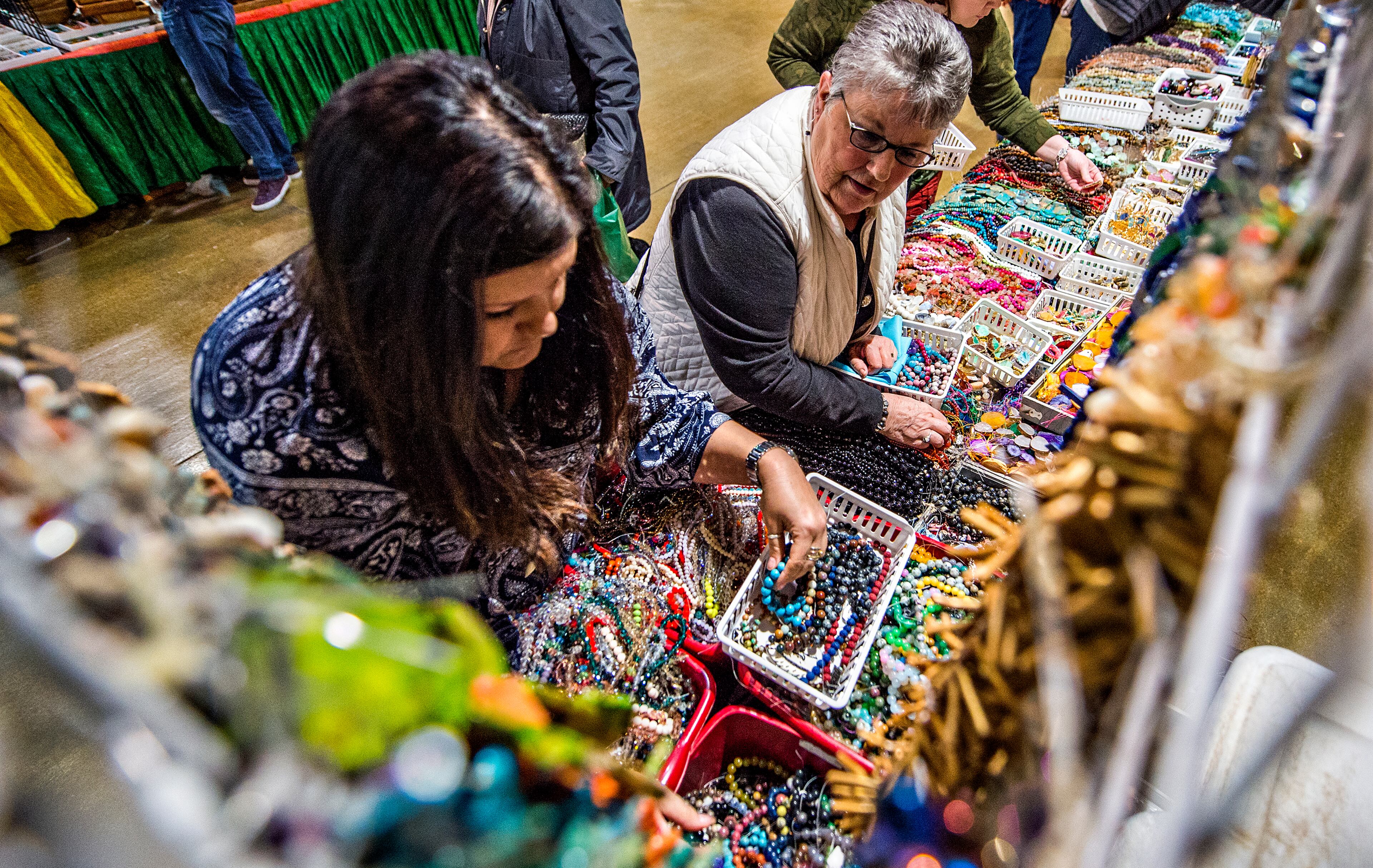 Gina Smith (left) and Vicky O'Bonnon check out the different beads for sale during the Intergalactic Bead Show at the Infinite Energy Center in Duluth on Saturday, Feb. 6, 2016. Tens of thousands of beads were up for grabs for artists, crafters and jewelry lovers during the show. JONATHAN PHILLIPS / SPECIAL