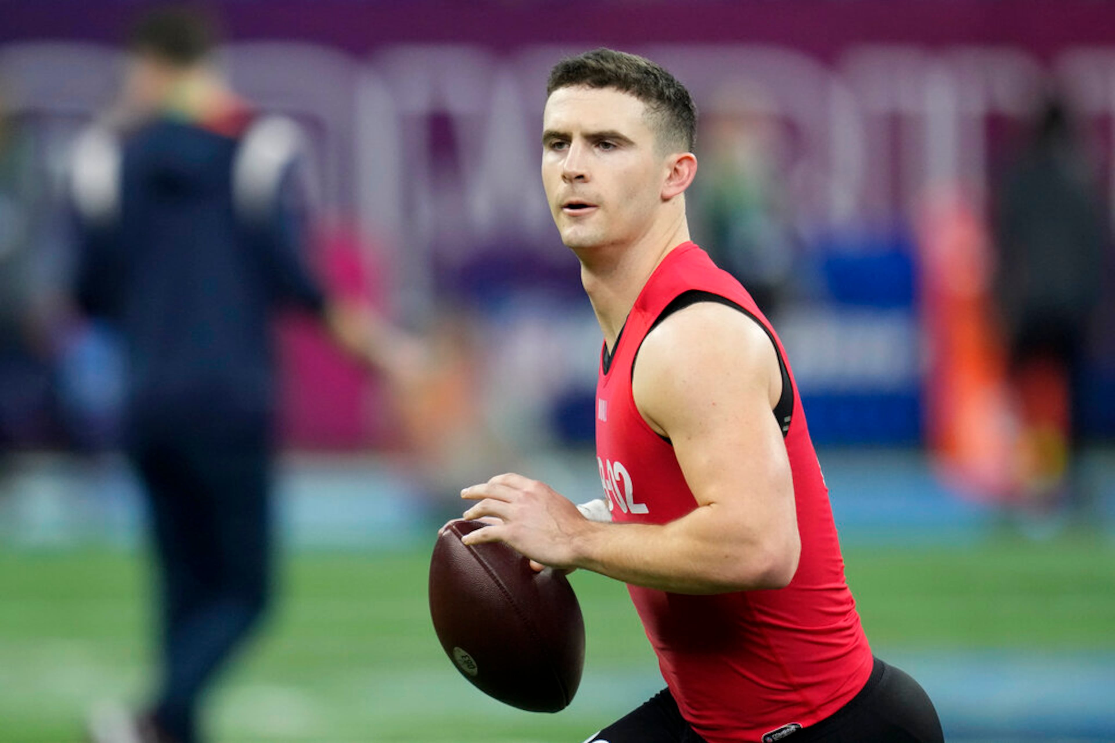 Georgia quarterback Stetson Bennett warms up before he runs a drill at the NFL football scouting combine in Indianapolis, Saturday, March 4, 2023. (AP Photo/Michael Conroy)