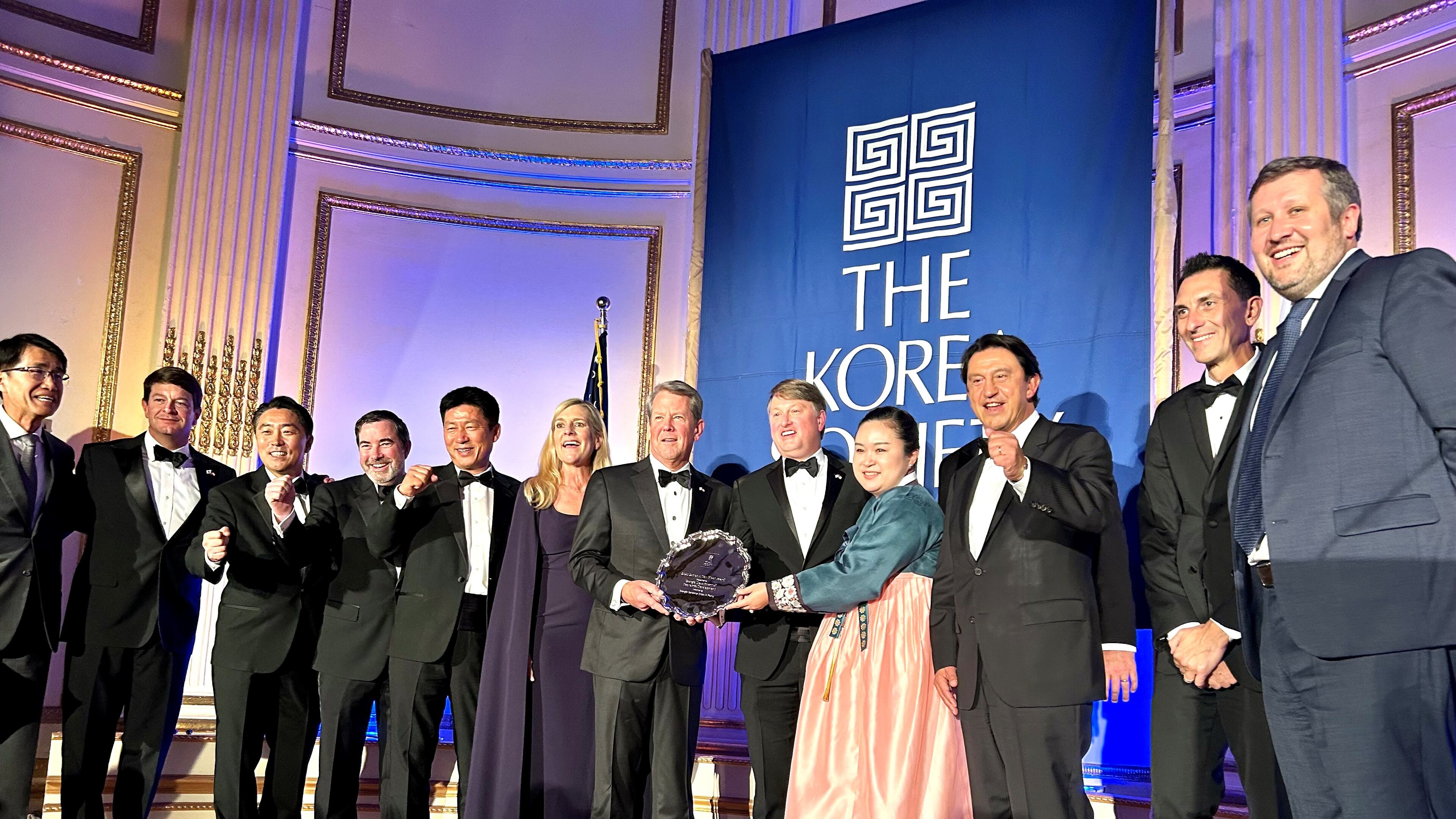 Gov. Brian Kemp, center, is joined by officials from the state, Hyundai Motor Group and other business and diplomatic officials at the annual Korea Society dinner. The state was honored with the Gen. James A. Van Fleet Award for its economic alliance with Korea. (J. Scott Trubey/AJC)