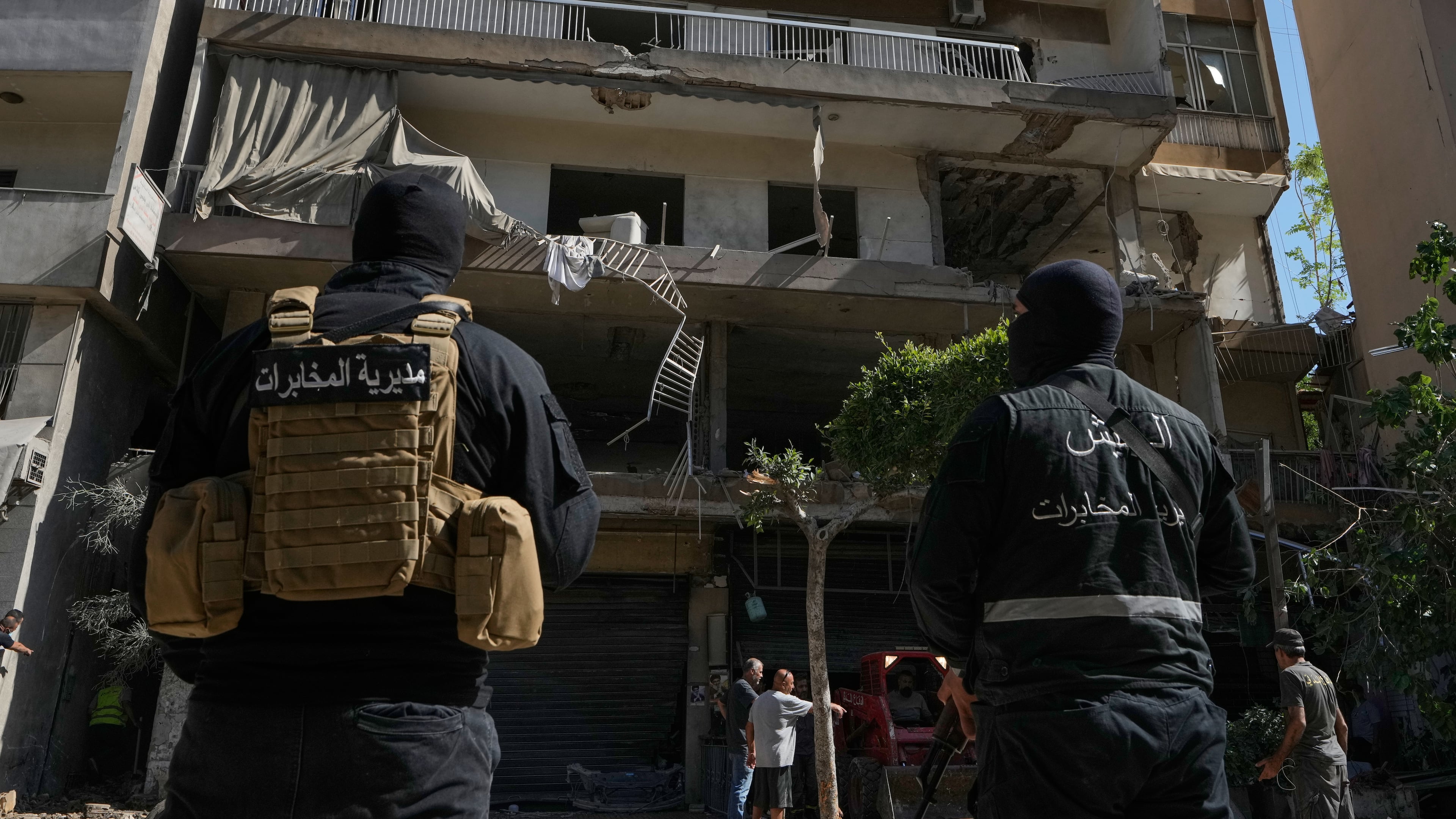 Members of the Lebanese Army Intelligence stand guard in front of an apartment that was struck in an Israeli airstrike in Dahiyeh, Beirut's southern suburbs, Lebanon, Sunday, June 14, 2026. (AP Photo/Bilal Hussein)