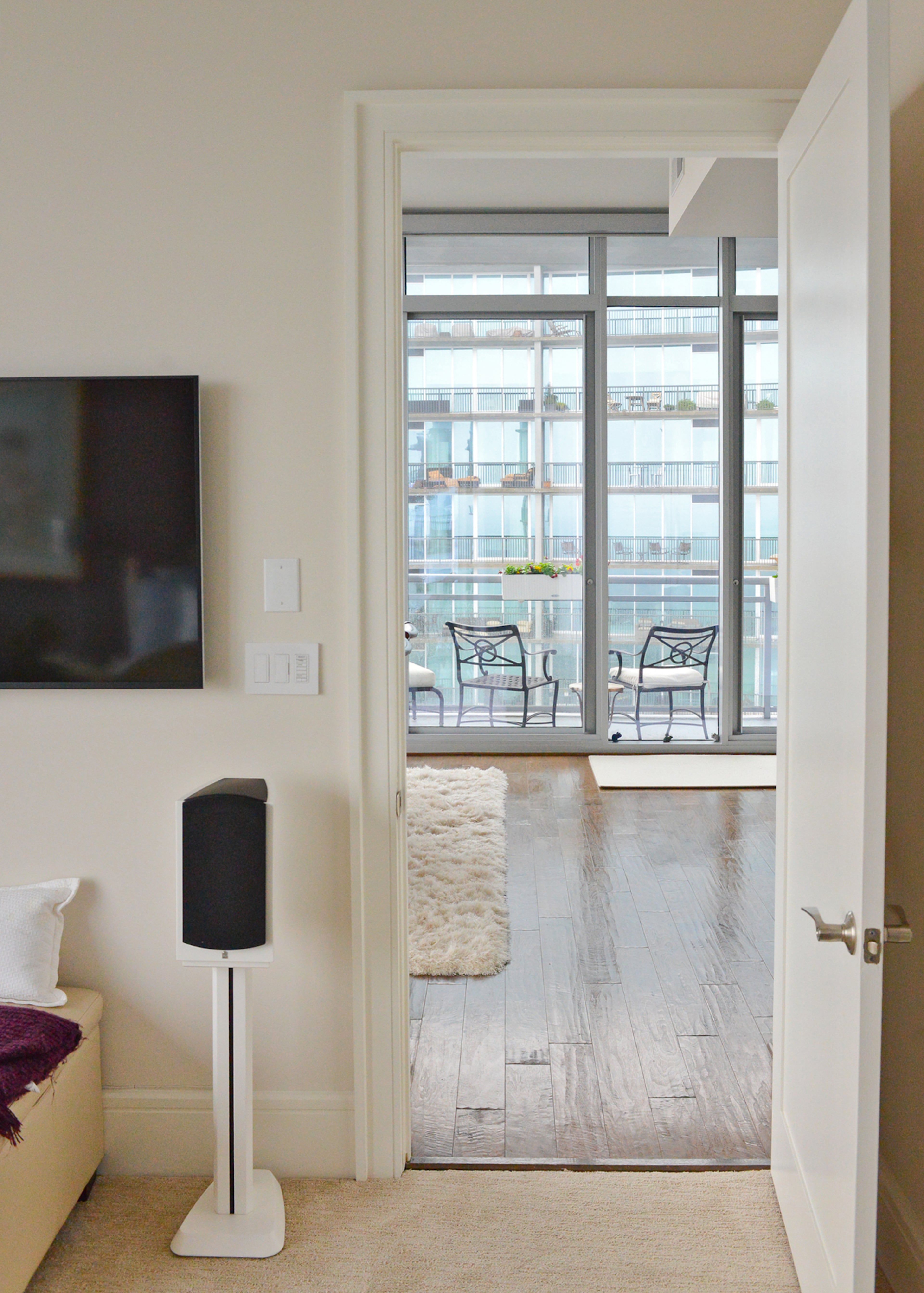 From the guest bedroom of the Midtown Atlanta high-rise condo, you can peek out and across Peachtree Street.