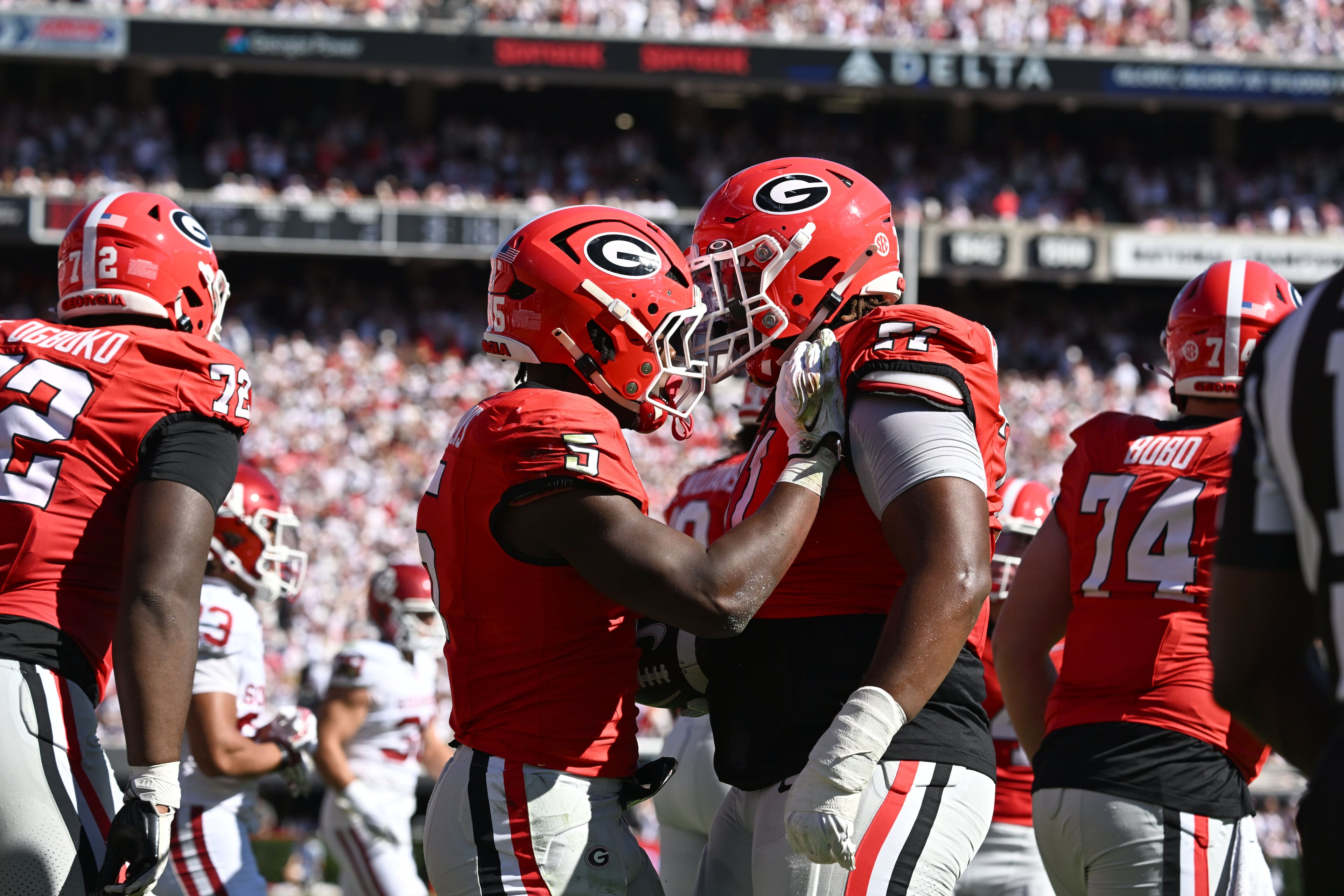 Georgia running back Chauncey Bowens (second from left) celebrates after scoring a touchdown against Oklahoma during the first half of an NCAA football game at Sanford Stadium on Saturday, Sept. 26, 2026, in Athens, Ga. (Hyosub Shin/AJC)