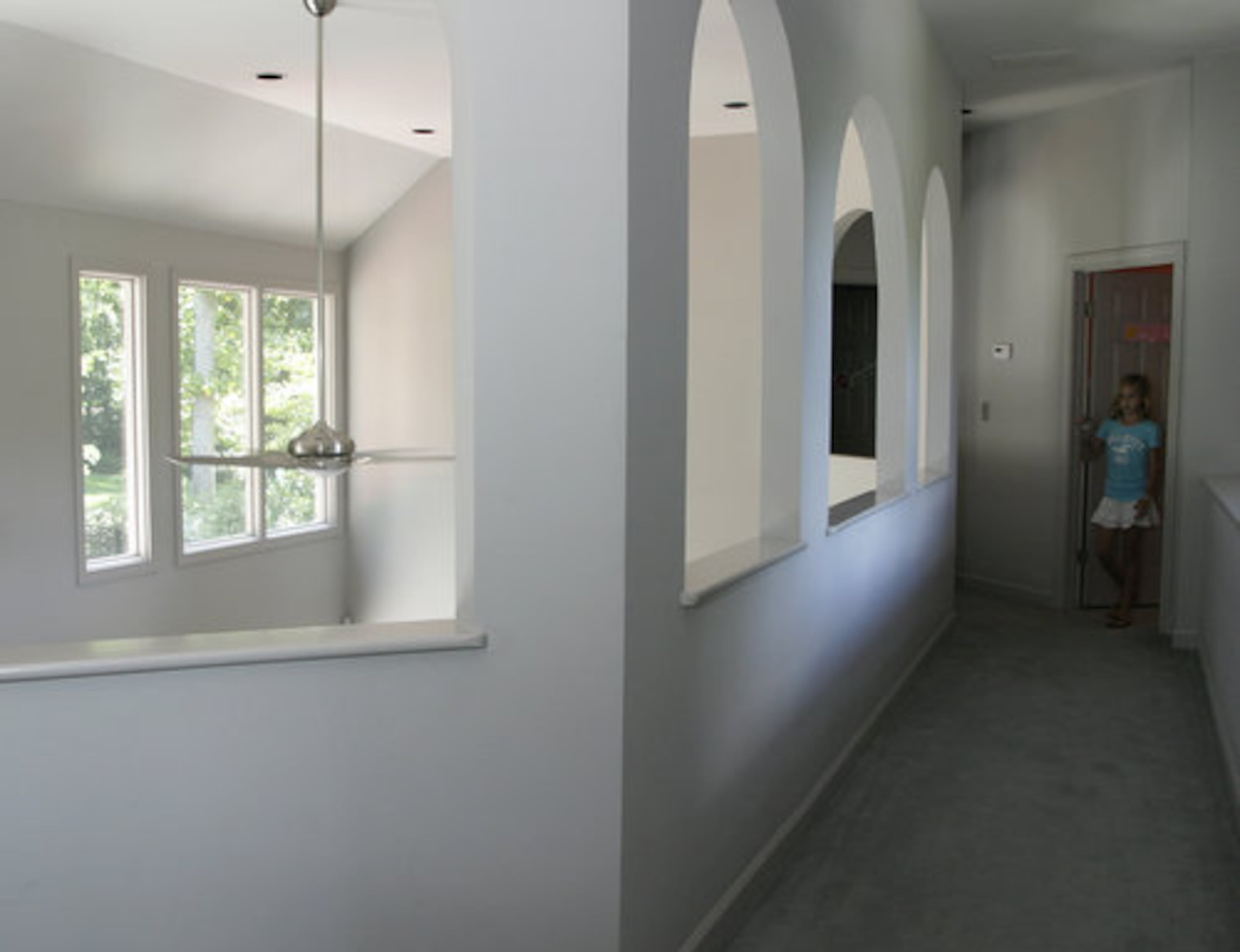 The archways in the upstairs hallway add visual interest and an open feel to the home.