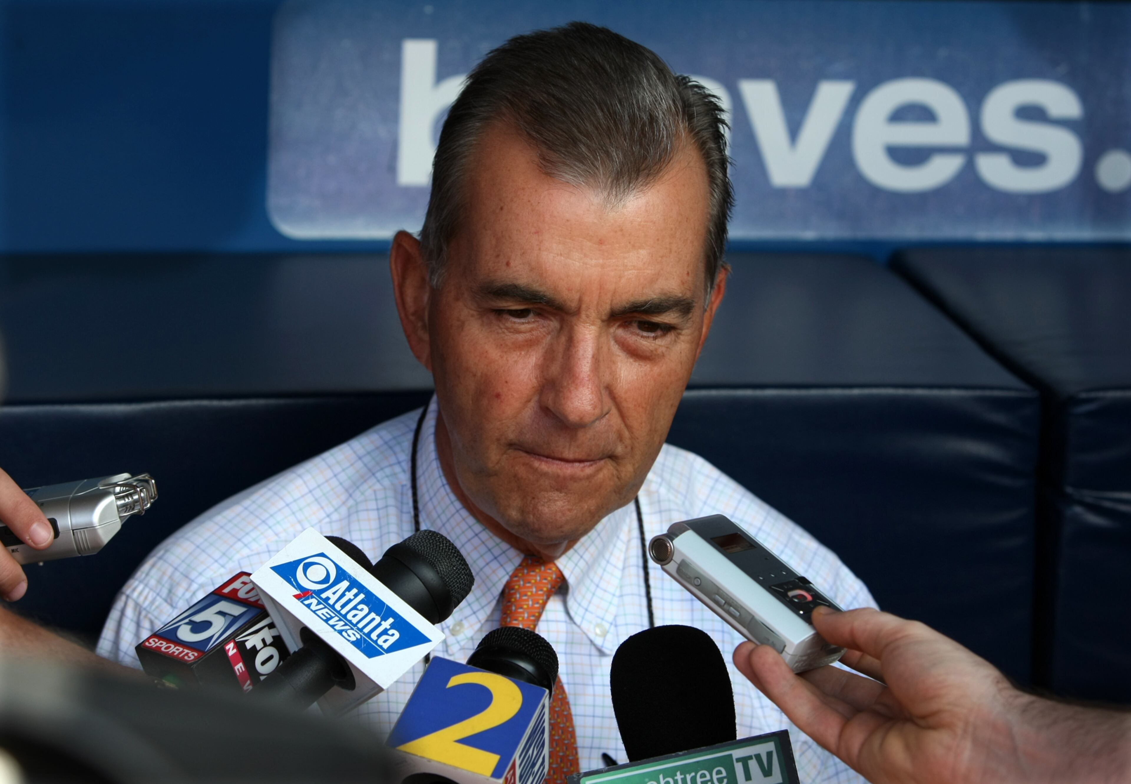 Braves team president John Schuerholz meets with the media in the dugout at Turner Field after apologizing to pitcher Tom Glavine for how his release was handled in 2009. CURTIS COMPTON / ccompton@ajc.com