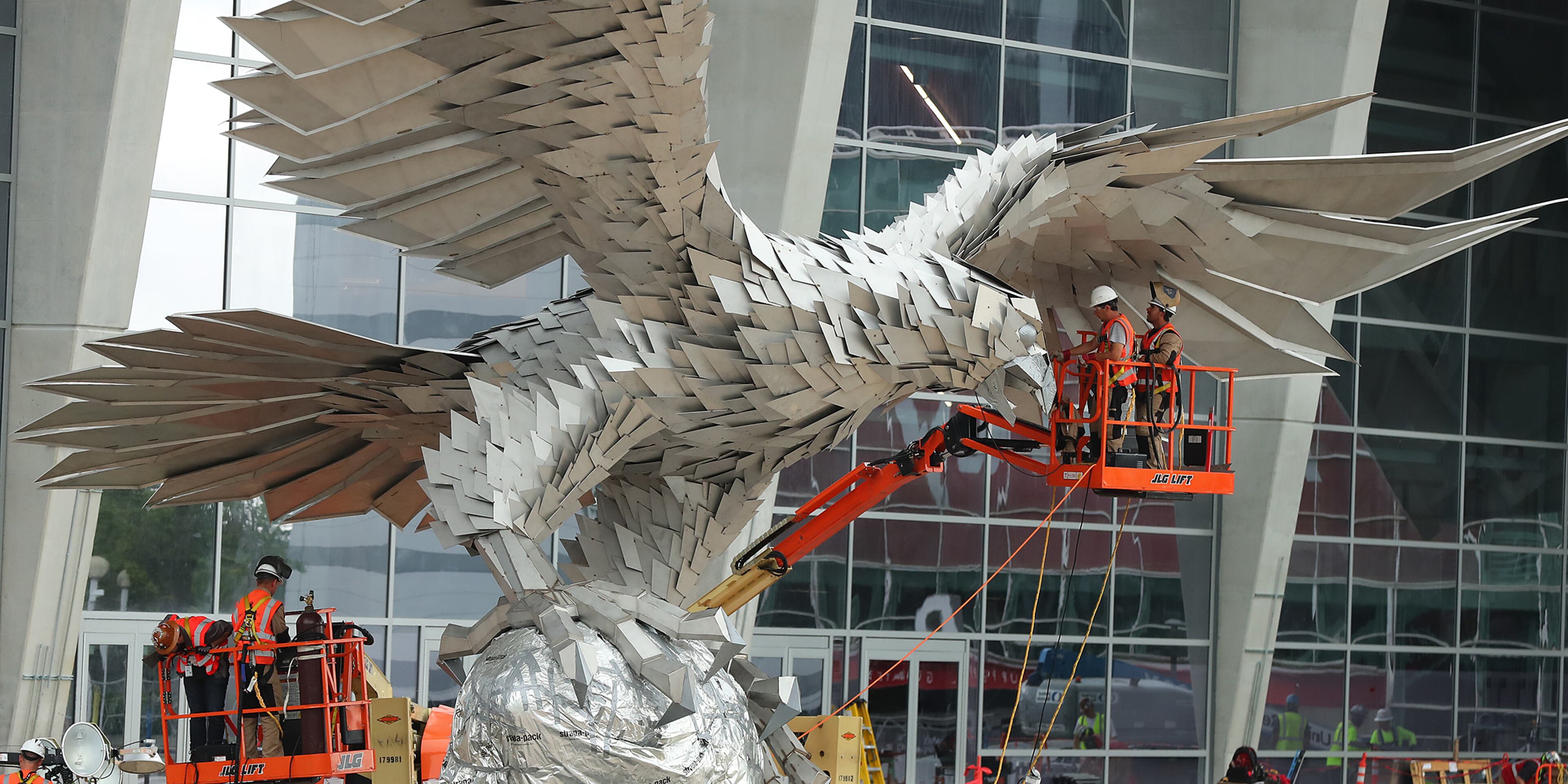 April 27, 2017, Atlanta: Workers install a 73,000 pound Falcons sculpture rising 41.5 feet tall with a wingspan of over 64 feet on the main plaza outside Mercedes-Benz stadium on Thursday, April 27, 2017, in Atlanta. Constructed by artist Gabor Miklos Szoke of Budapest, the stainless steel work captures the moment of a touchdown. Curtis Compton/ccompton@ajc.com