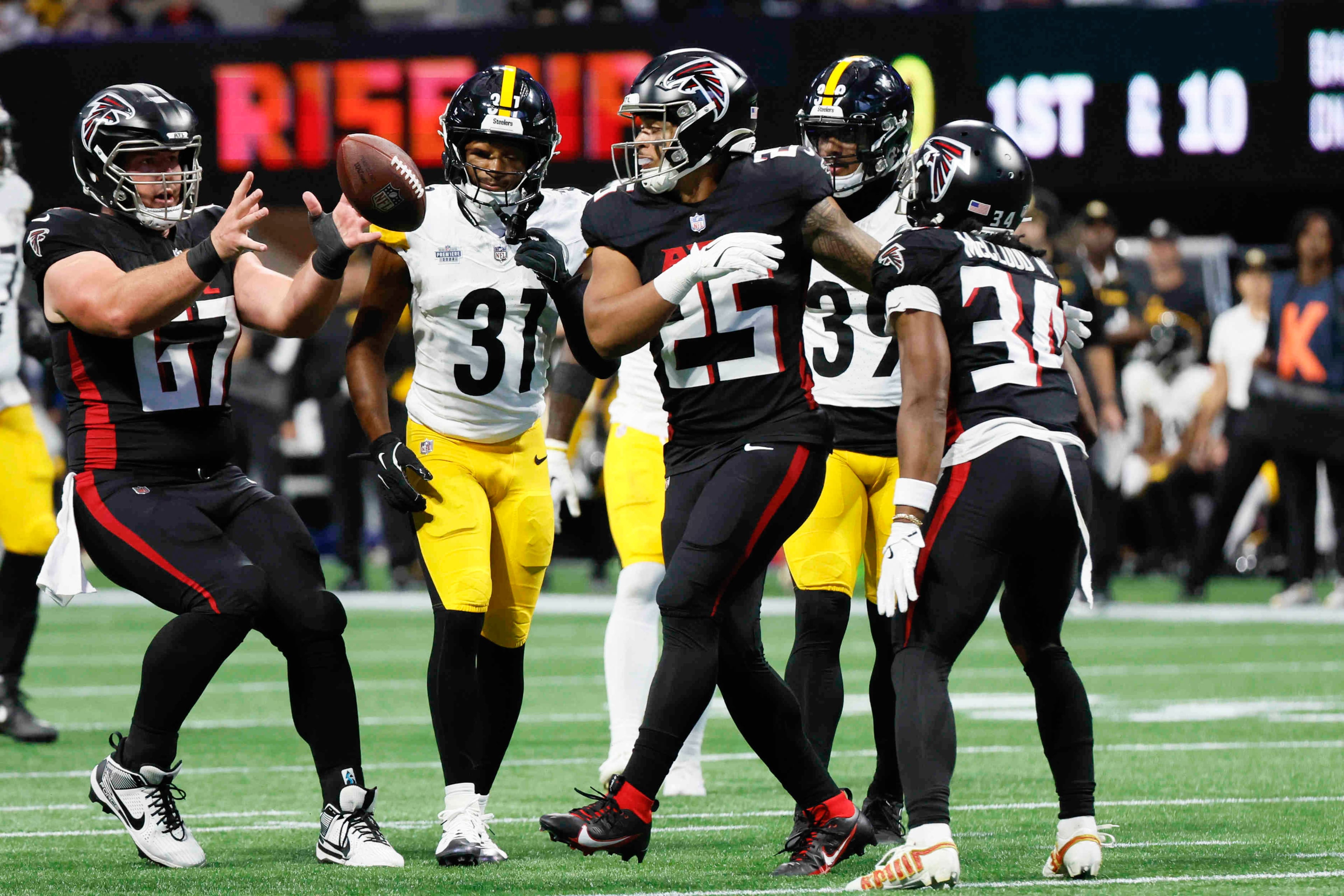 Falcons running back Tyler Allgeier (25) tosses the ball after a first down during the first half of an NFL football game against the Steelers on Sunday, Sept. 8, at Mercedes-Benz Stadium in Atlanta.
(Miguel Martinez/ AJC)
