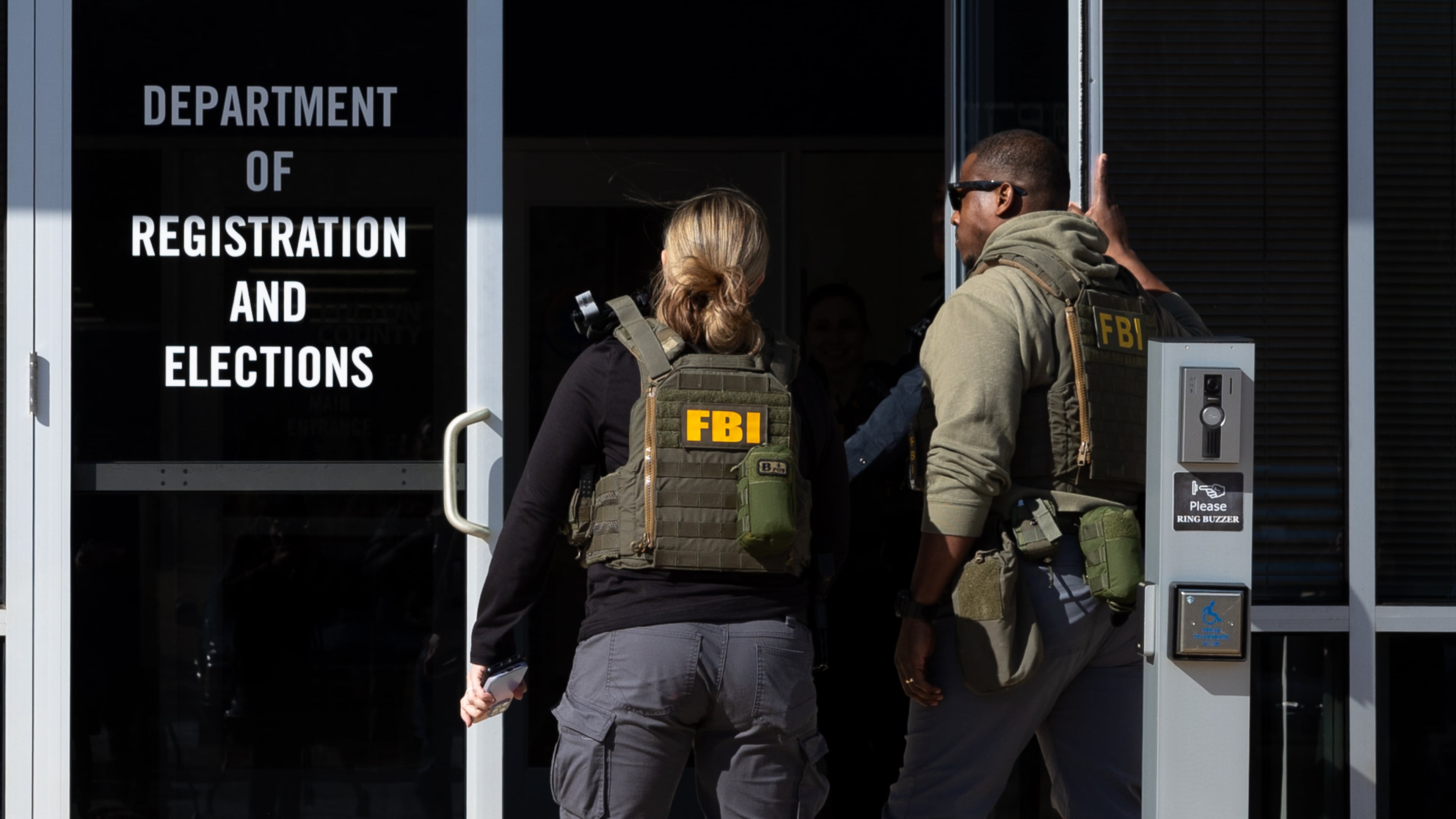 FBI agents enter the Fulton County Election Hub and Operation Center in Union City on Wednesday, Jan. 28, 2026, as the FBI conducts a raid. (Arvin Temkar/AJC)