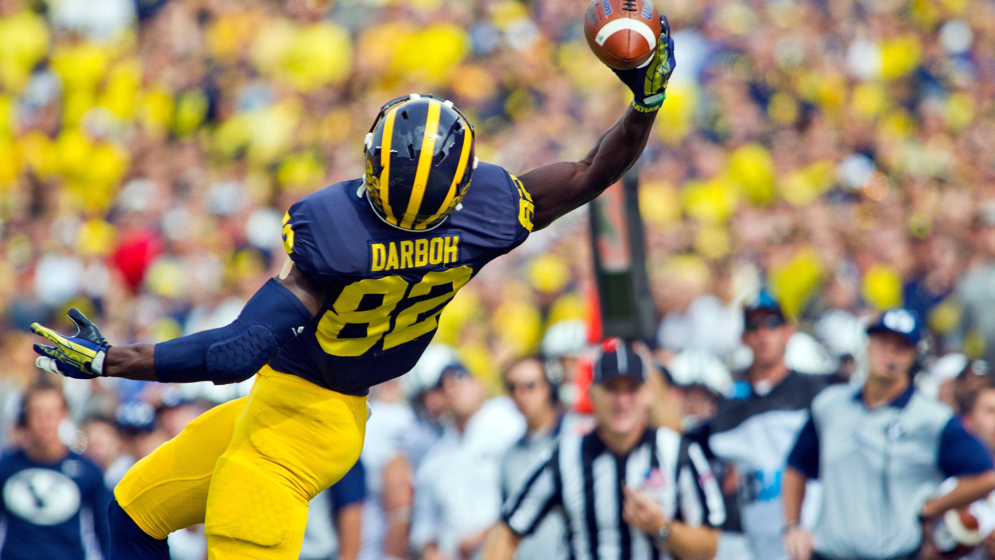 Michigan wide receiver Amara Darboh (82) makes a one-handed catch in the first quarter of an NCAA college football game against BYU in Ann Arbor, Mich., Saturday, Sept. 26, 2015. (AP Photo/Tony Ding)