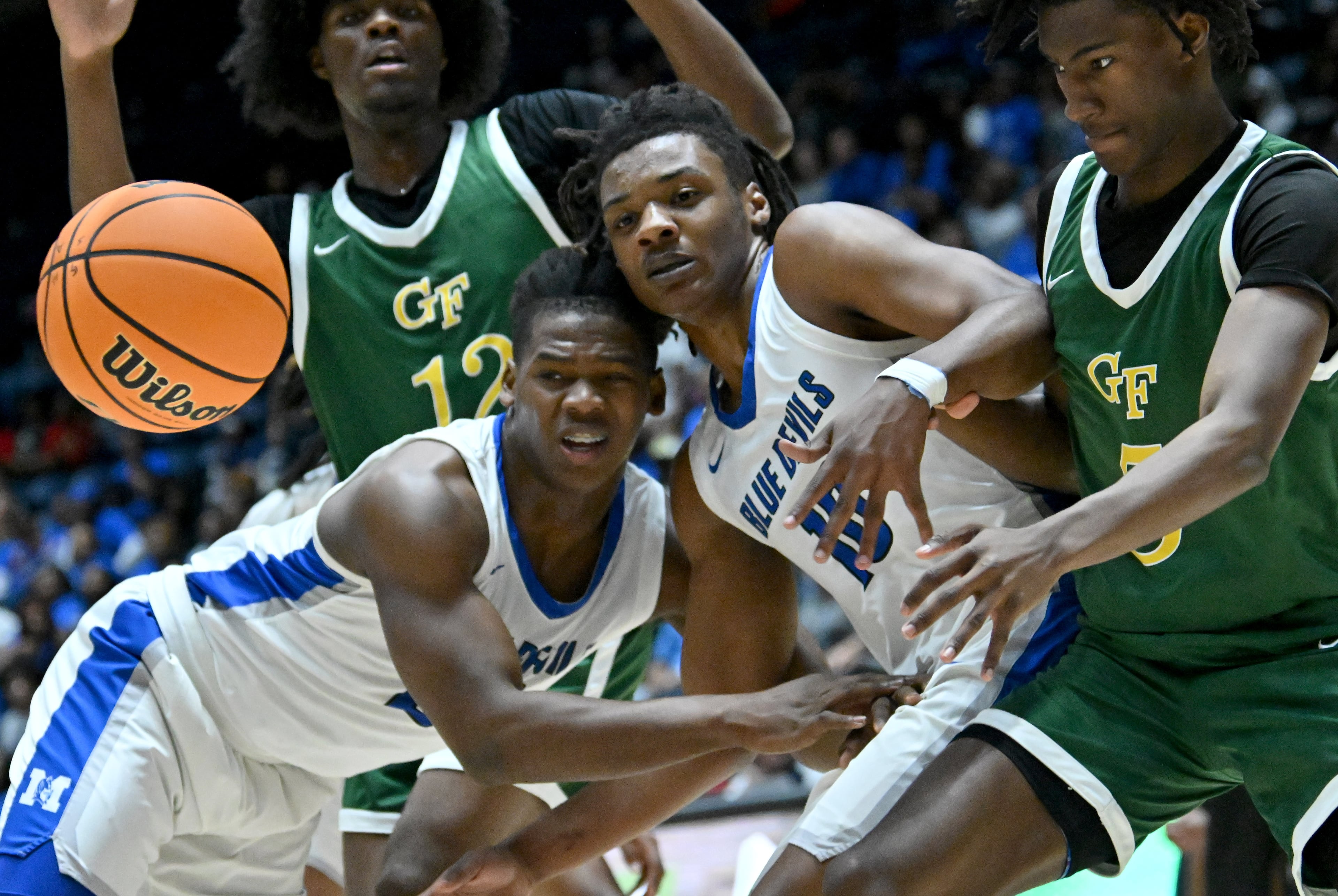 Manchester's CJ Favors (21) and Manchester's Jhi Terry (10) go for a loose ball during the first half of GHSA Basketball Class A Division II Boy’s State Championship game at the Macon Centreplex, Wednesday, Mar. 6, 2024, in Macon. (Hyosub Shin / Hyosub.Shin@ajc.com)