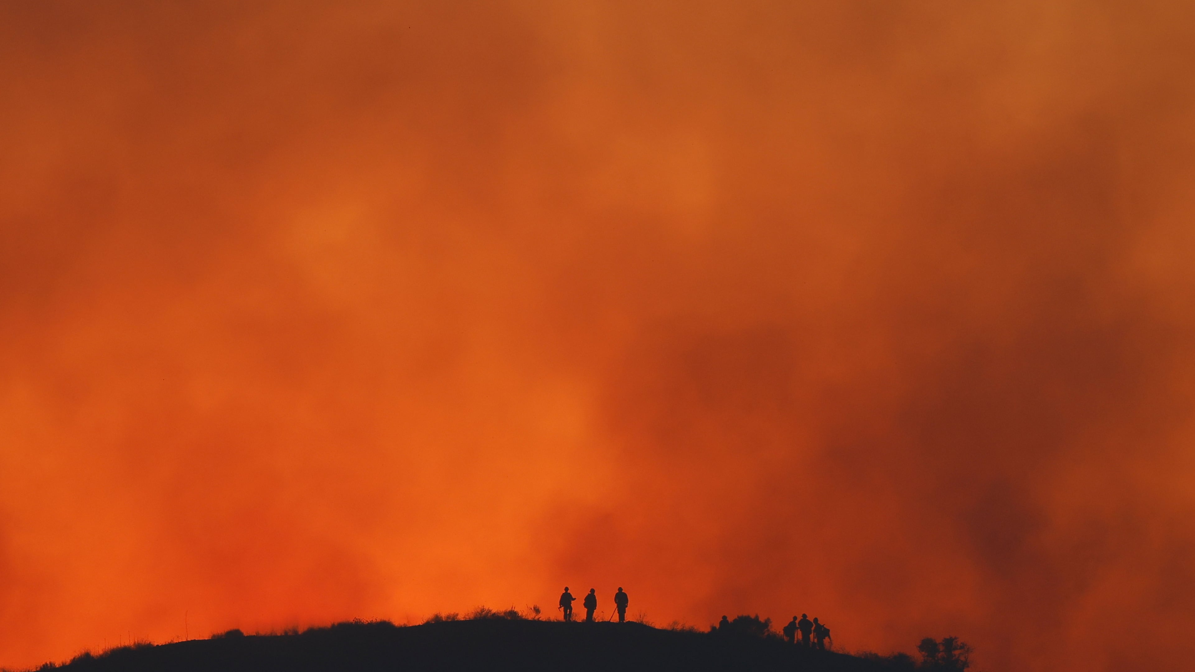 FILE - Firefighters are silhouetted amid an operation to control the Sandy Fire, May 19, 2026, in Simi Valley, Calif. (AP Photo/Caroline Brehman, File)